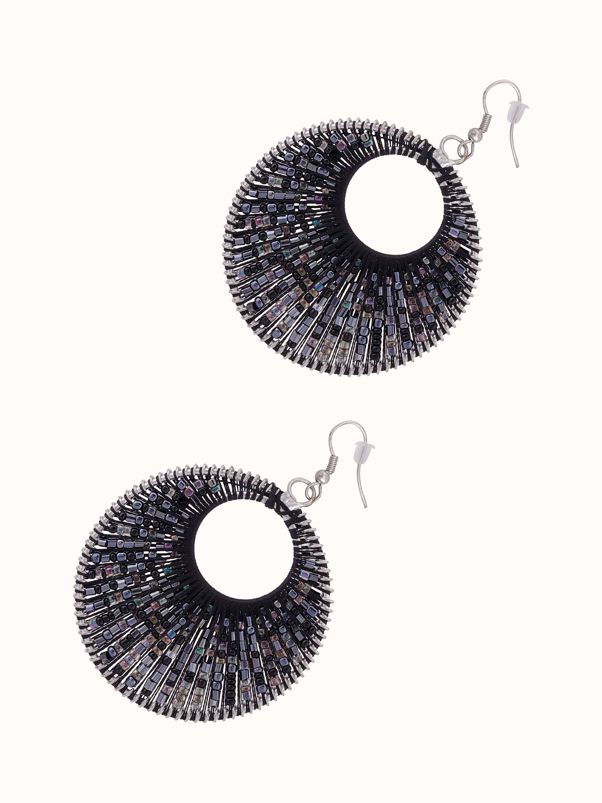 Angled view of handcrafted drop earrings emphasizing their elegant and artistic design