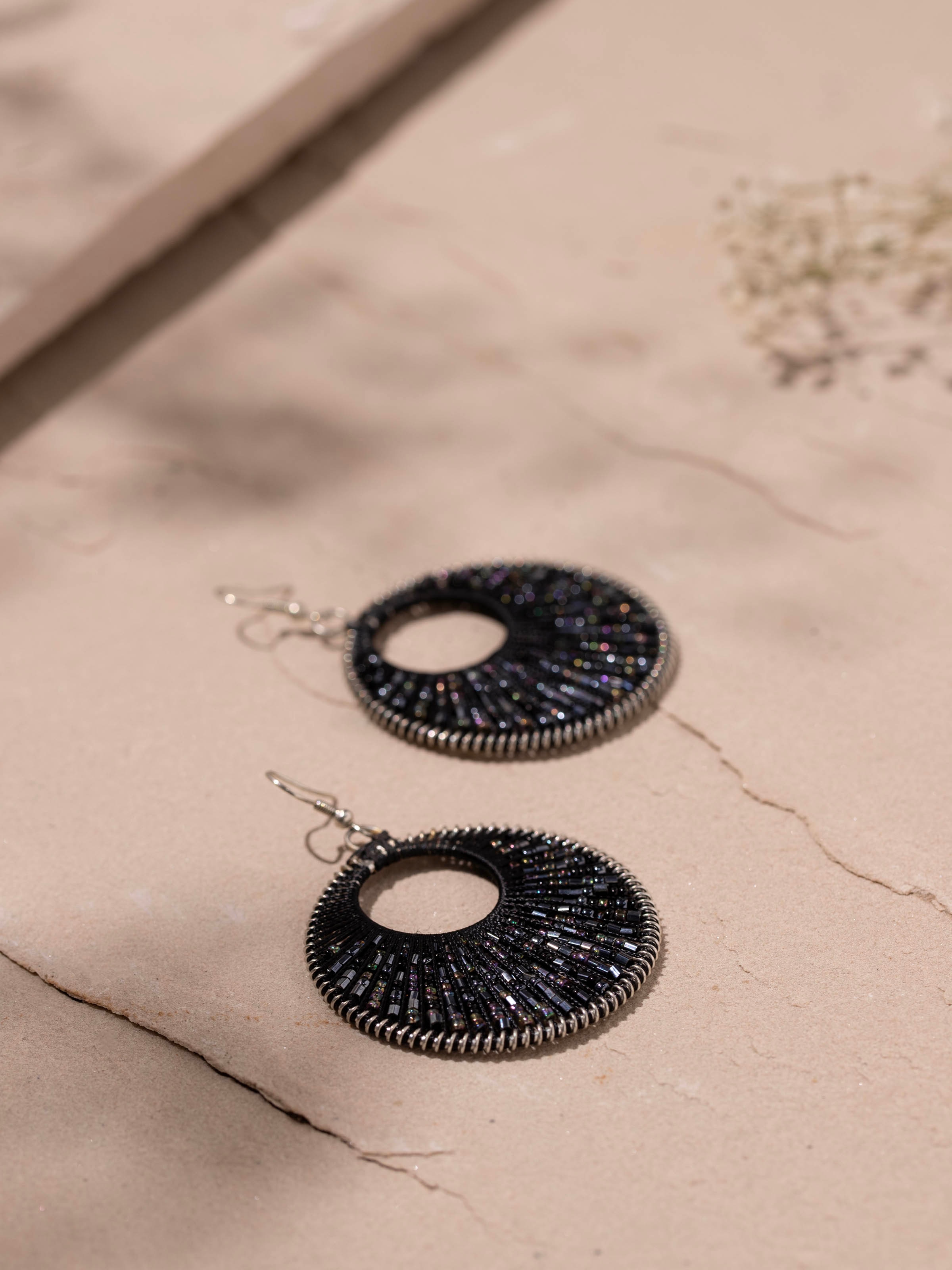 Detailed front view of handcrafted drop earrings showcasing their intricate design and artistry
