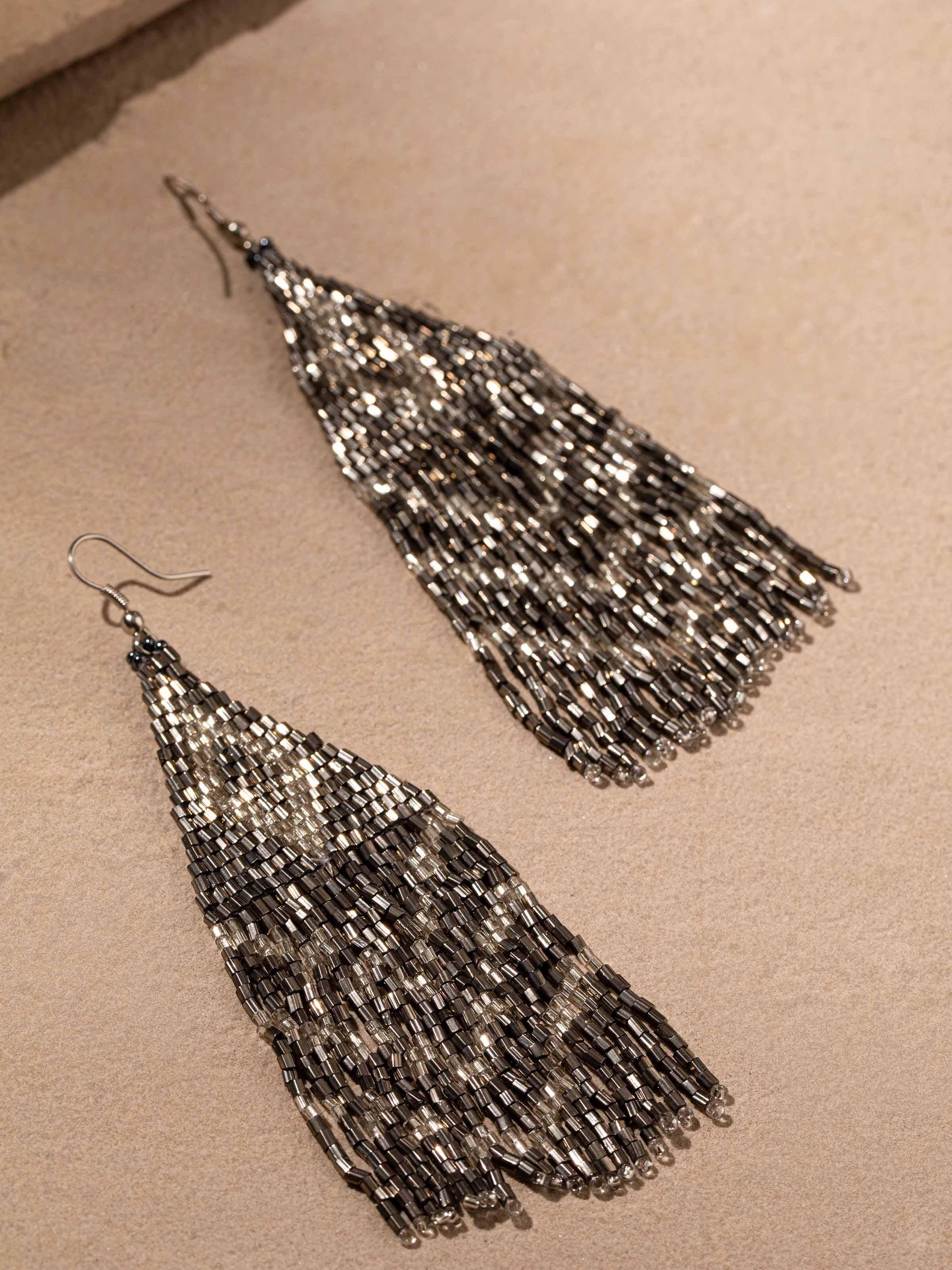 Back view of handcrafted drop earrings showing secure clasp and detailed design.