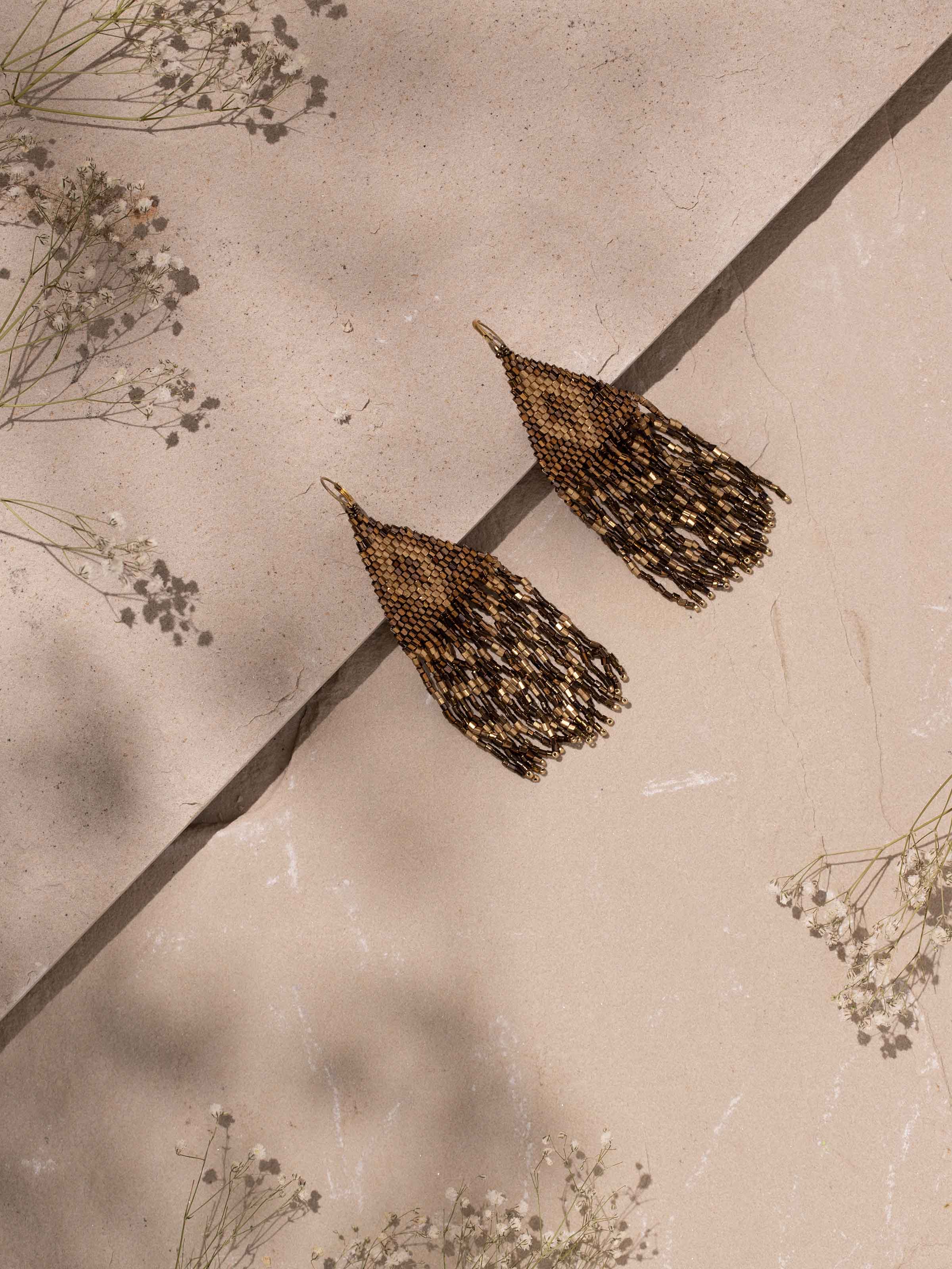 Close-up view of Handcrafted Drop Earrings highlighting intricate details.