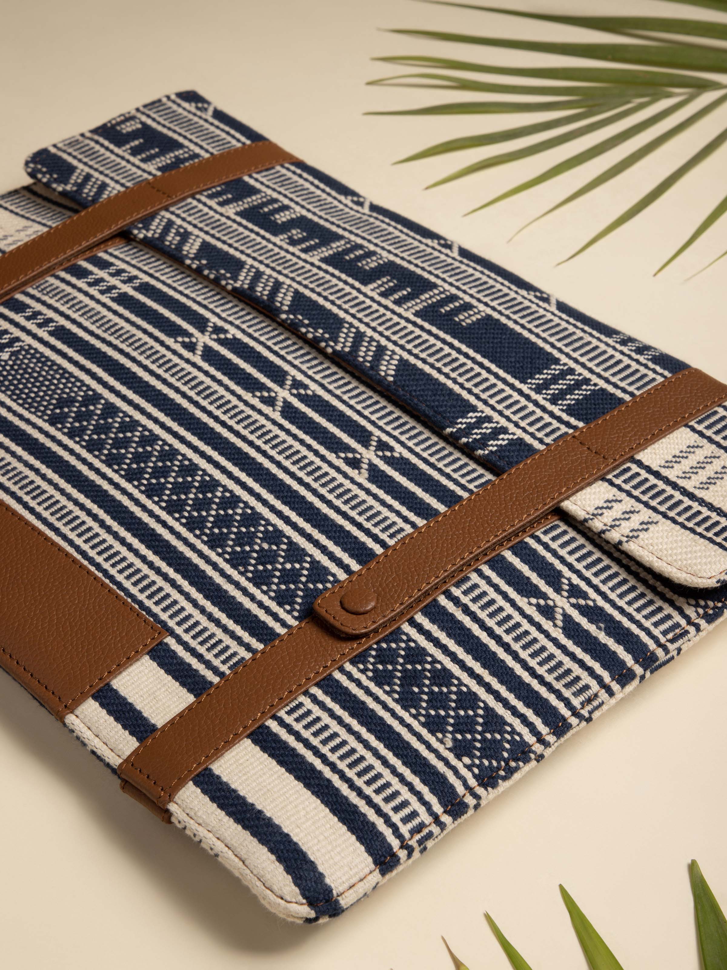 Side view of leather and textile laptop sleeve showcasing the sleek profile and stitching details