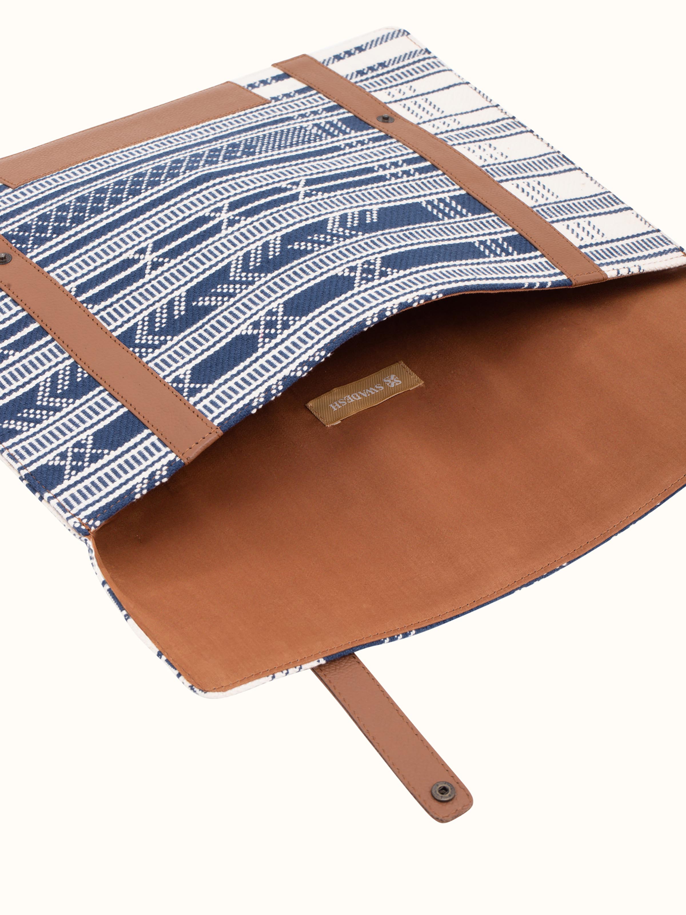 Close-up of leather and textile laptop sleeve focusing on the material texture and detail