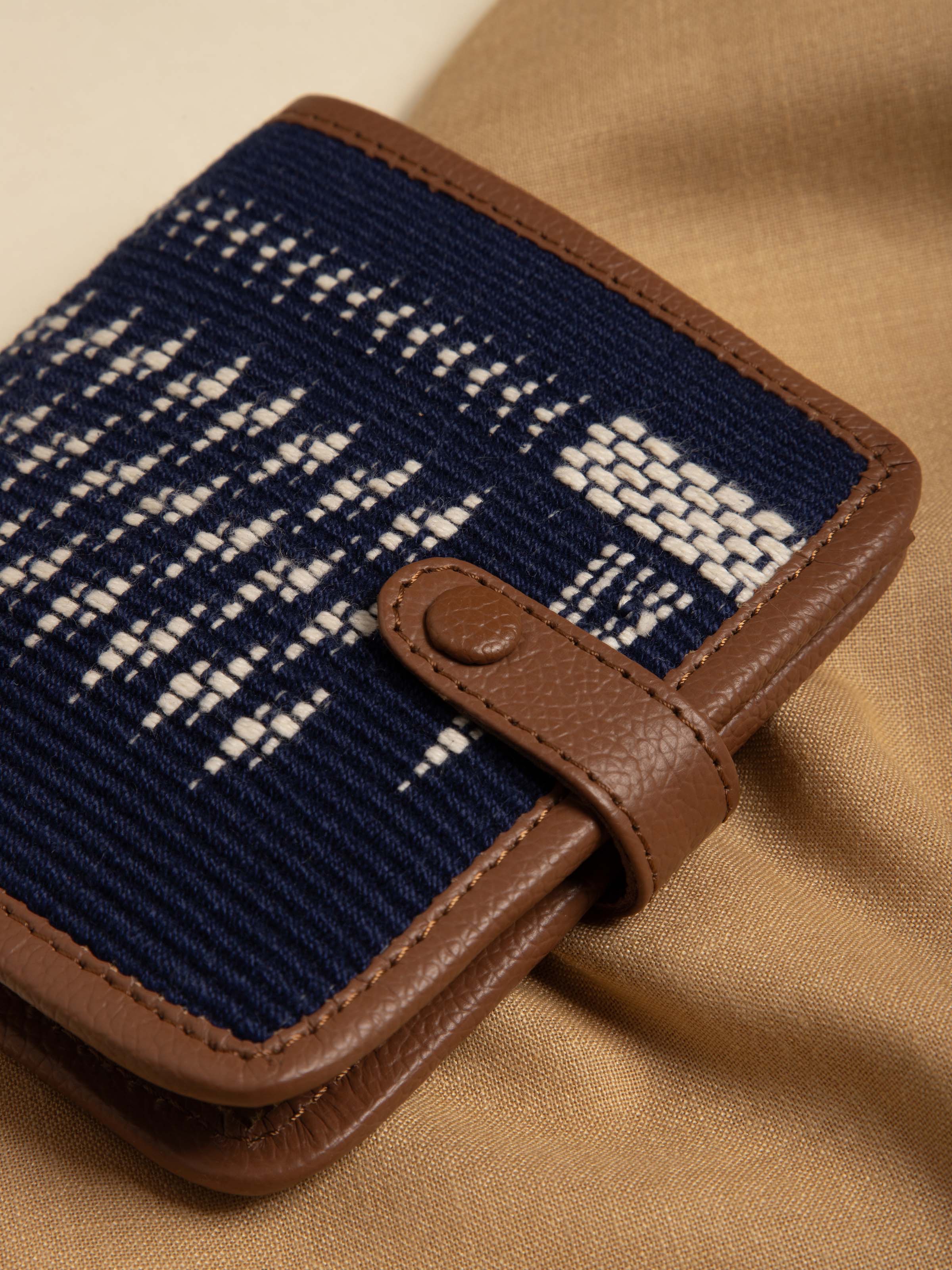 Close-up of leather and textile Nagaland loin loom wallet emphasizing loom patterns and leather texture