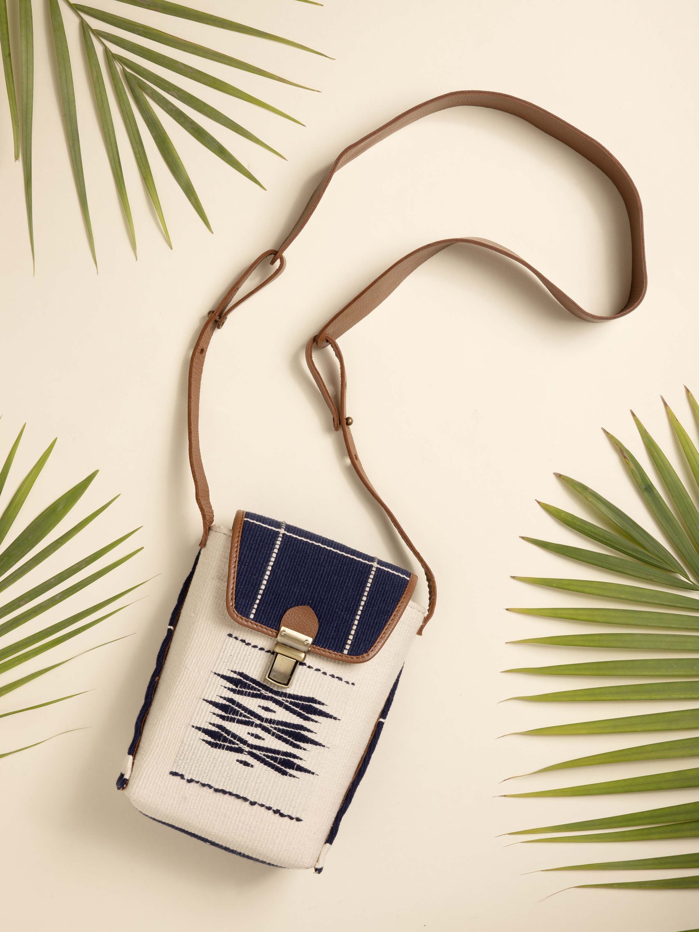 Side view of leather & textile Nagaland loin loom sling bag highlighting detailed textile patterns