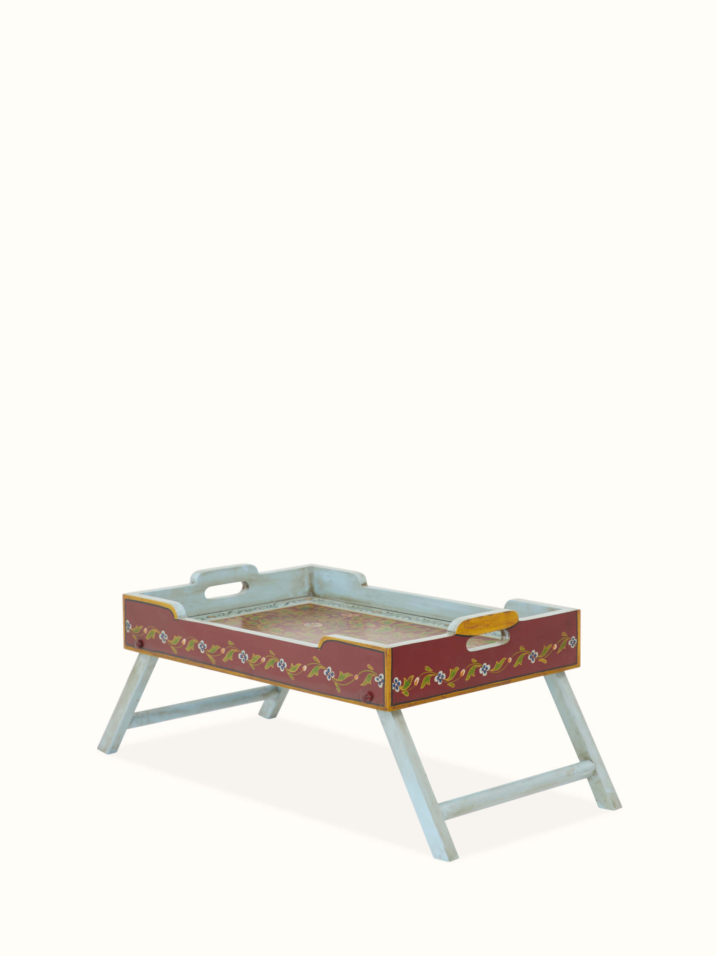 Close-up of the painted surface of the miniature rectangular table, showcasing the artistic patterns and craftsmanship.