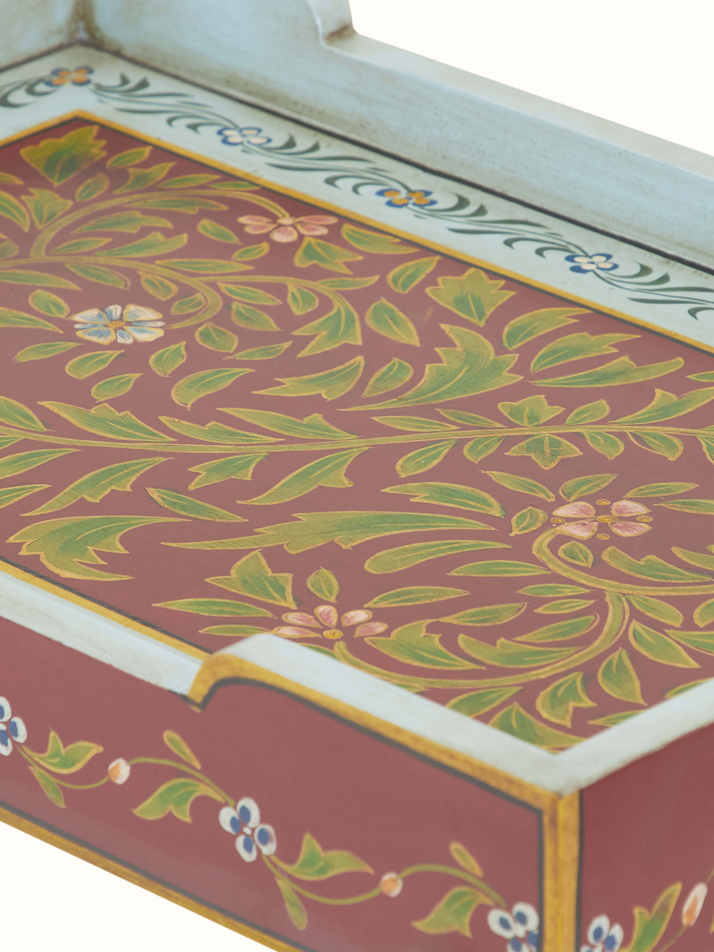 Detailed view of the table legs and painted surface, emphasizing the intricate patterns and durable construction.