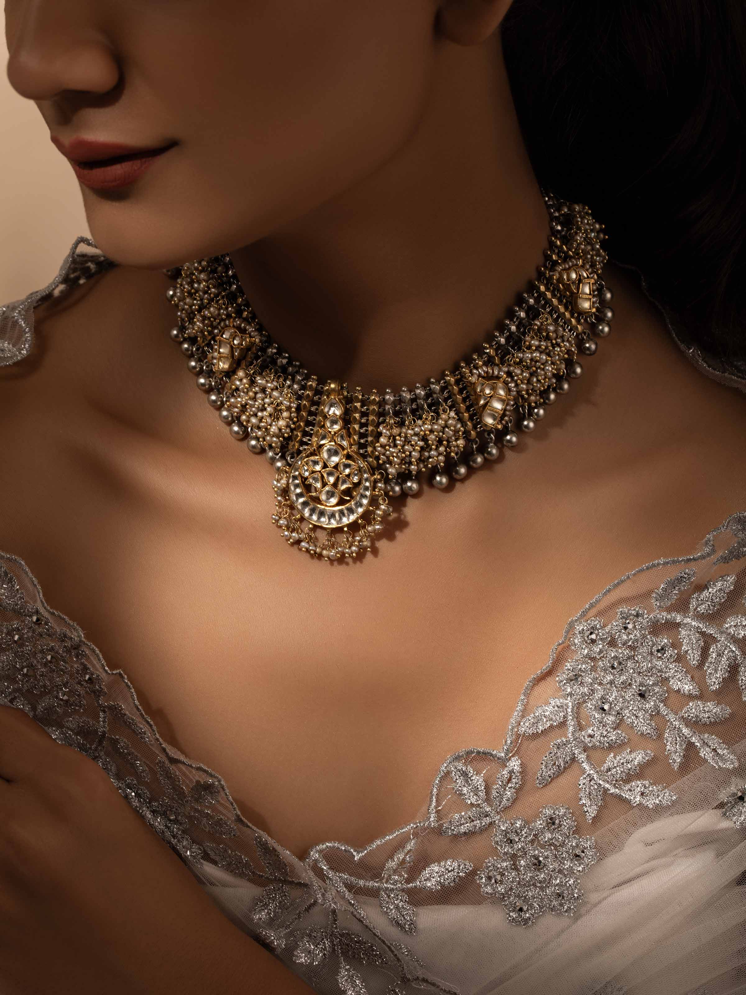 Side view of Silver Smithing Collar Necklace showcasing the necklace's intricate silver design and fit