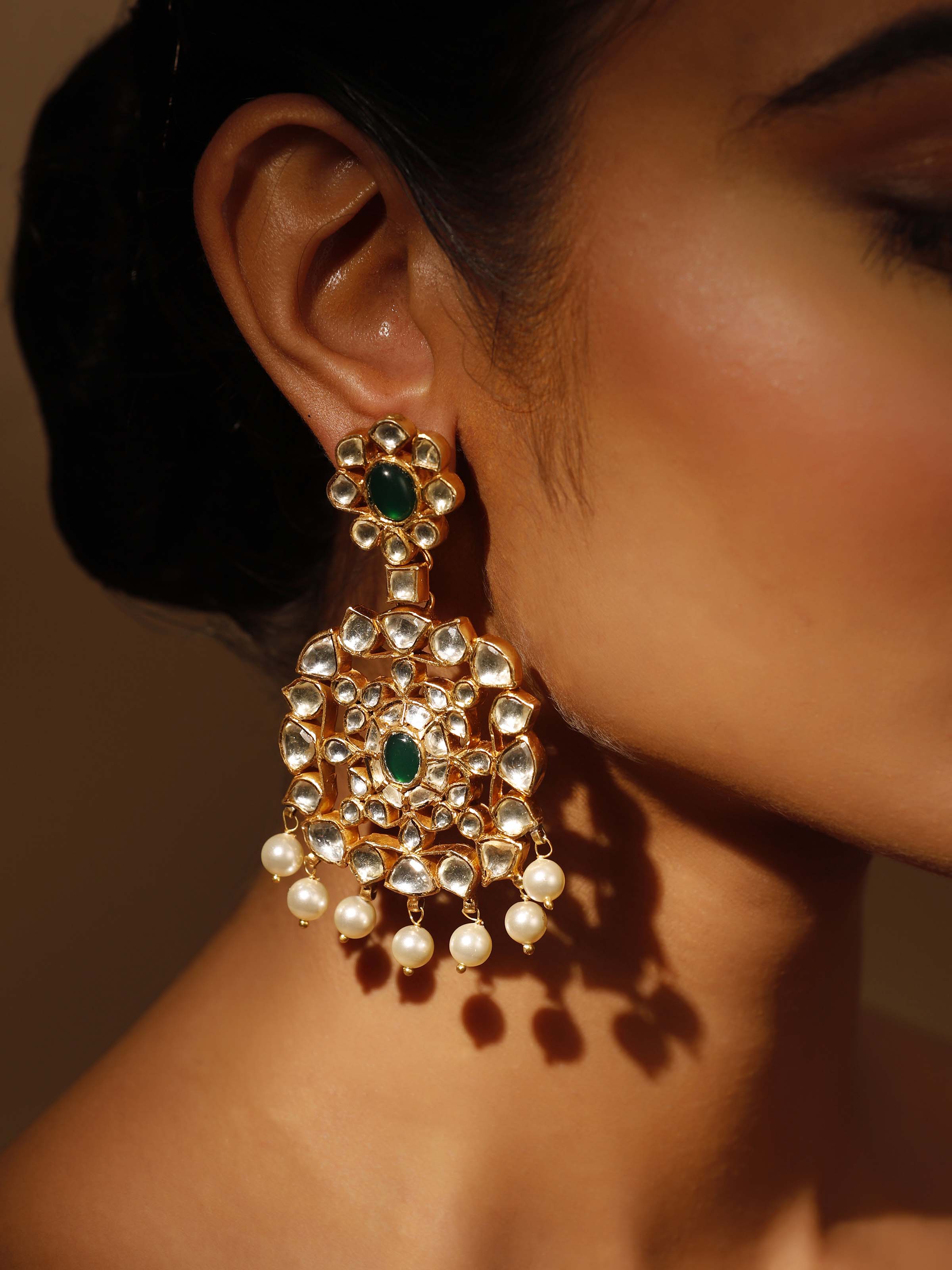 Angled view of Silver Smithing Drop Earrings emphasizing intricate metal design.