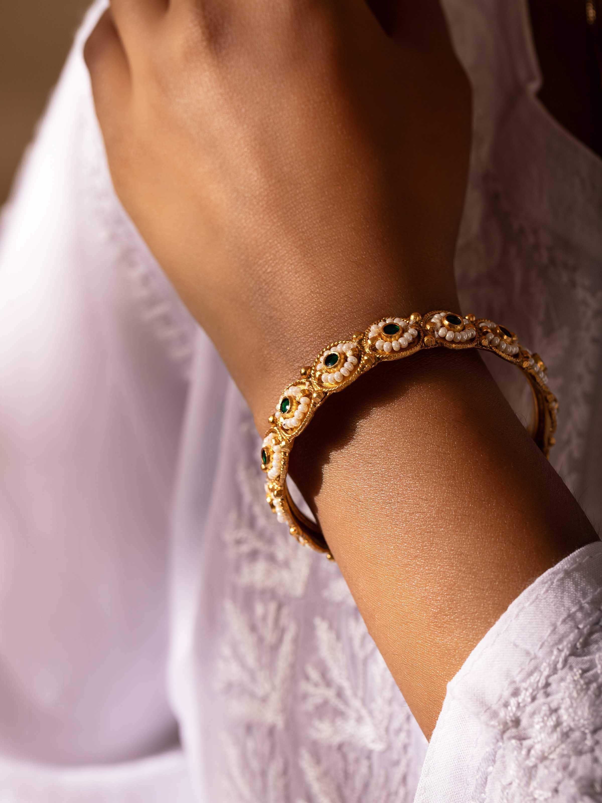 Side view of Silver Smithing Bangle showing the elegant curves and detailed silver work.
