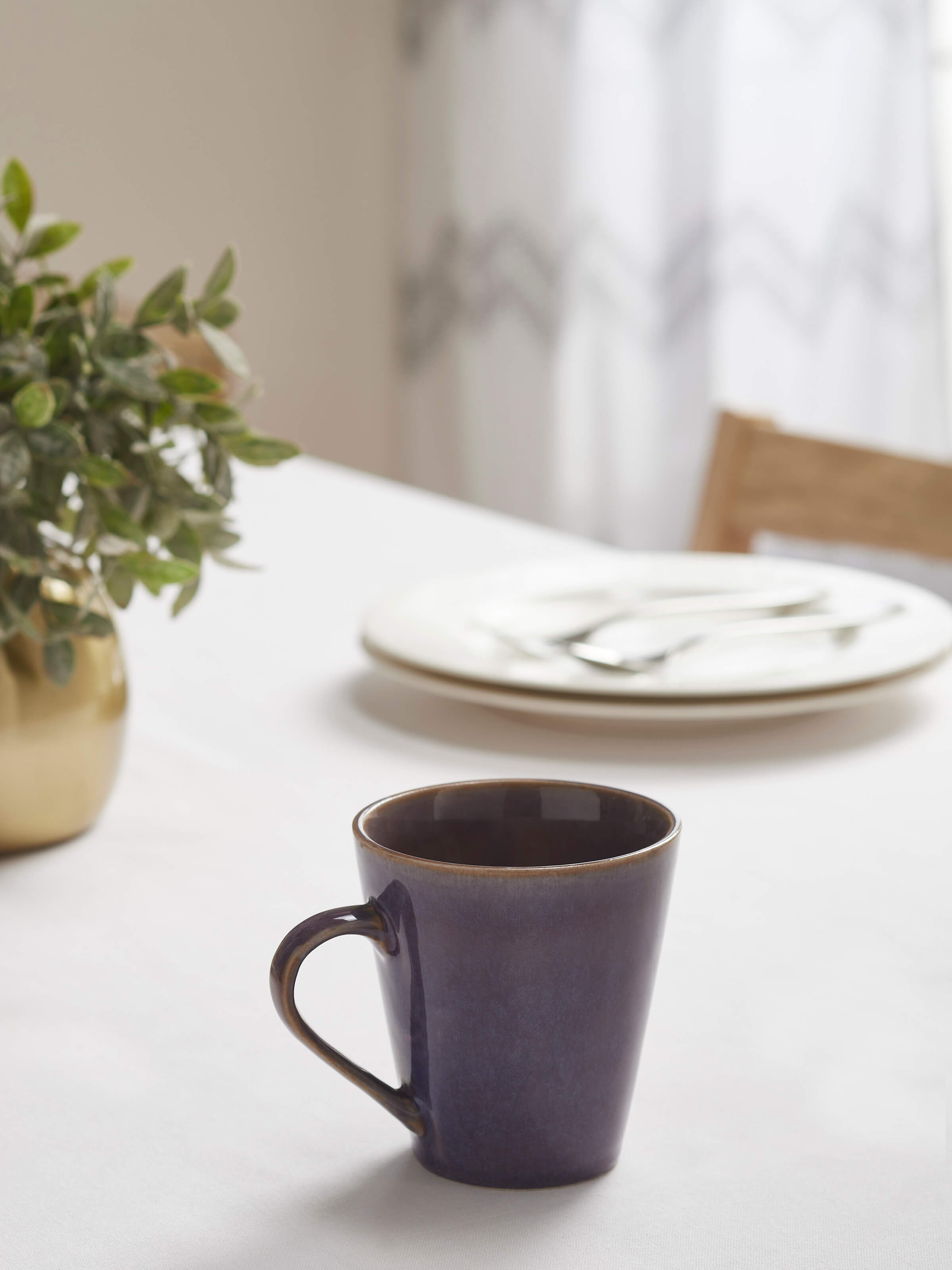 Side view of Khurja pottery ceramic coffee mug in black, highlighting its shape and texture.