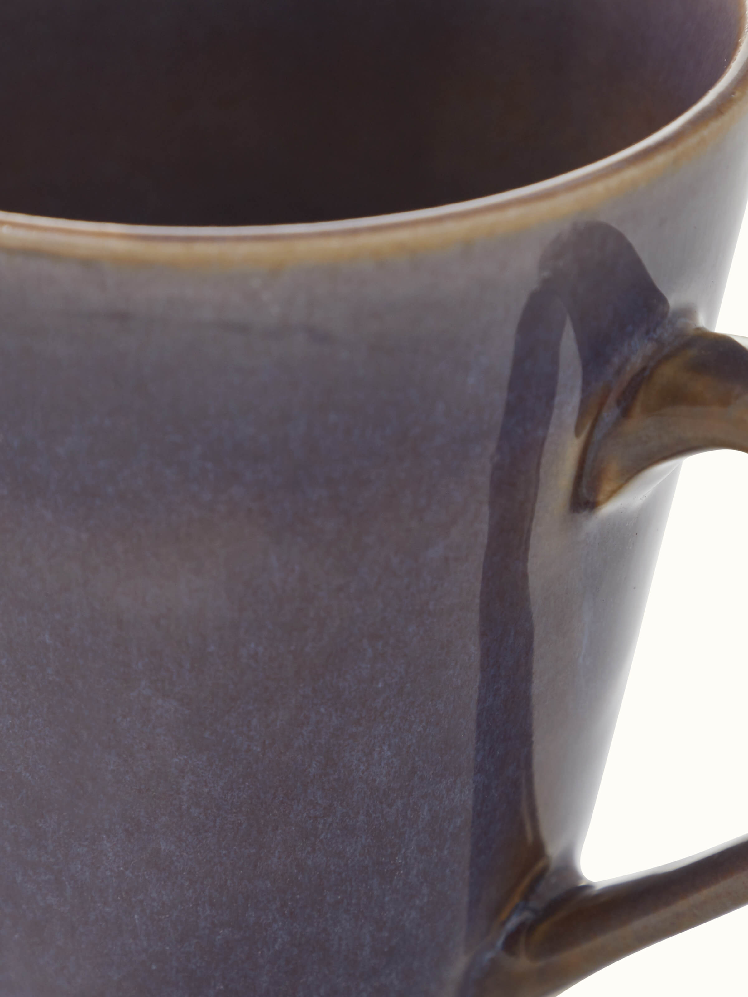 Close-up of Khurja pottery ceramic coffee mug in black, focusing on the fine details and glaze.
