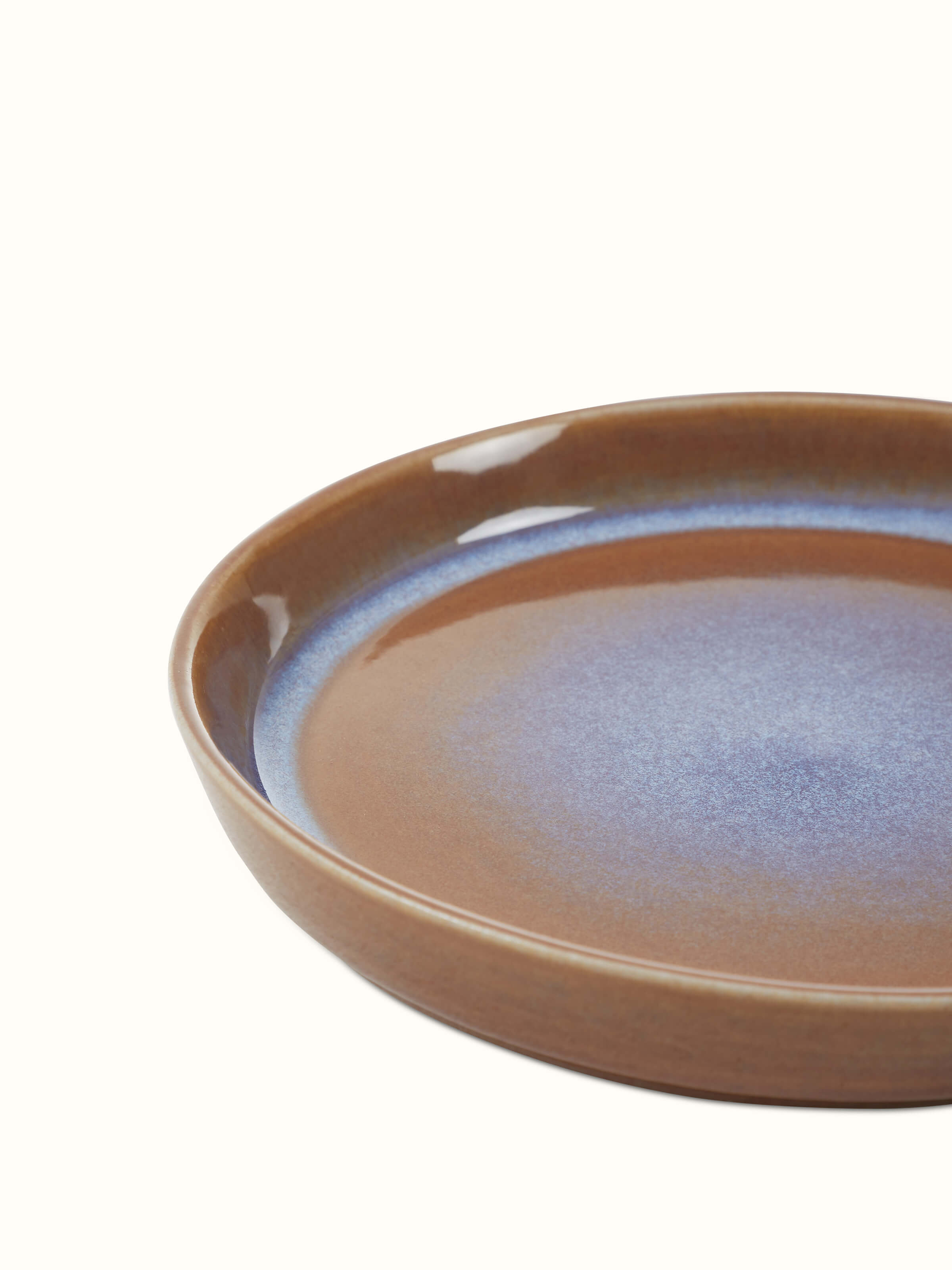 View of Khurja pottery ceramic salad plates stacked together, showcasing their consistent design and color.