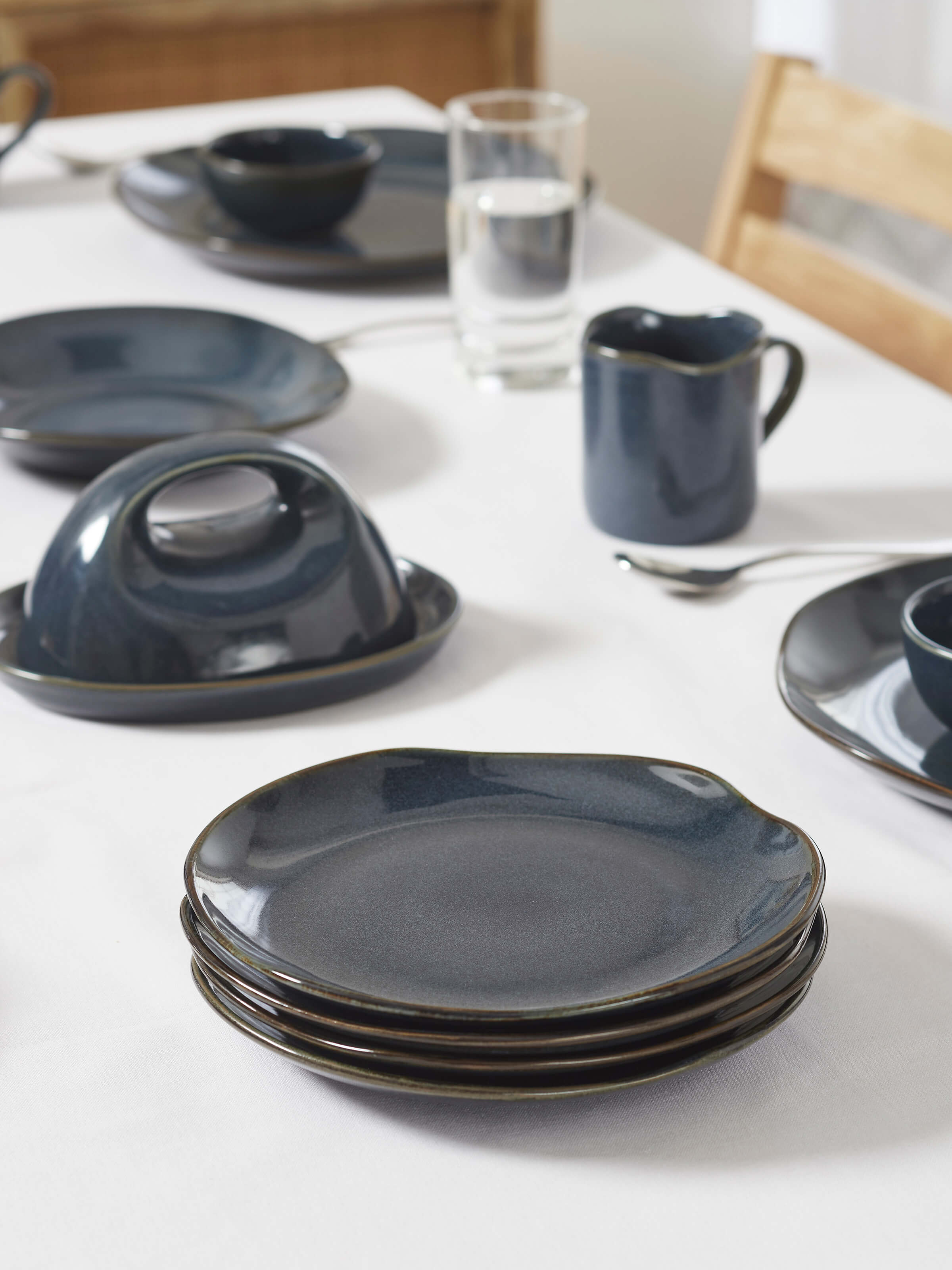 Side view of Khurja pottery ceramic dinner plates in black (4 pcs) highlighting the elegant curves and sturdy construction