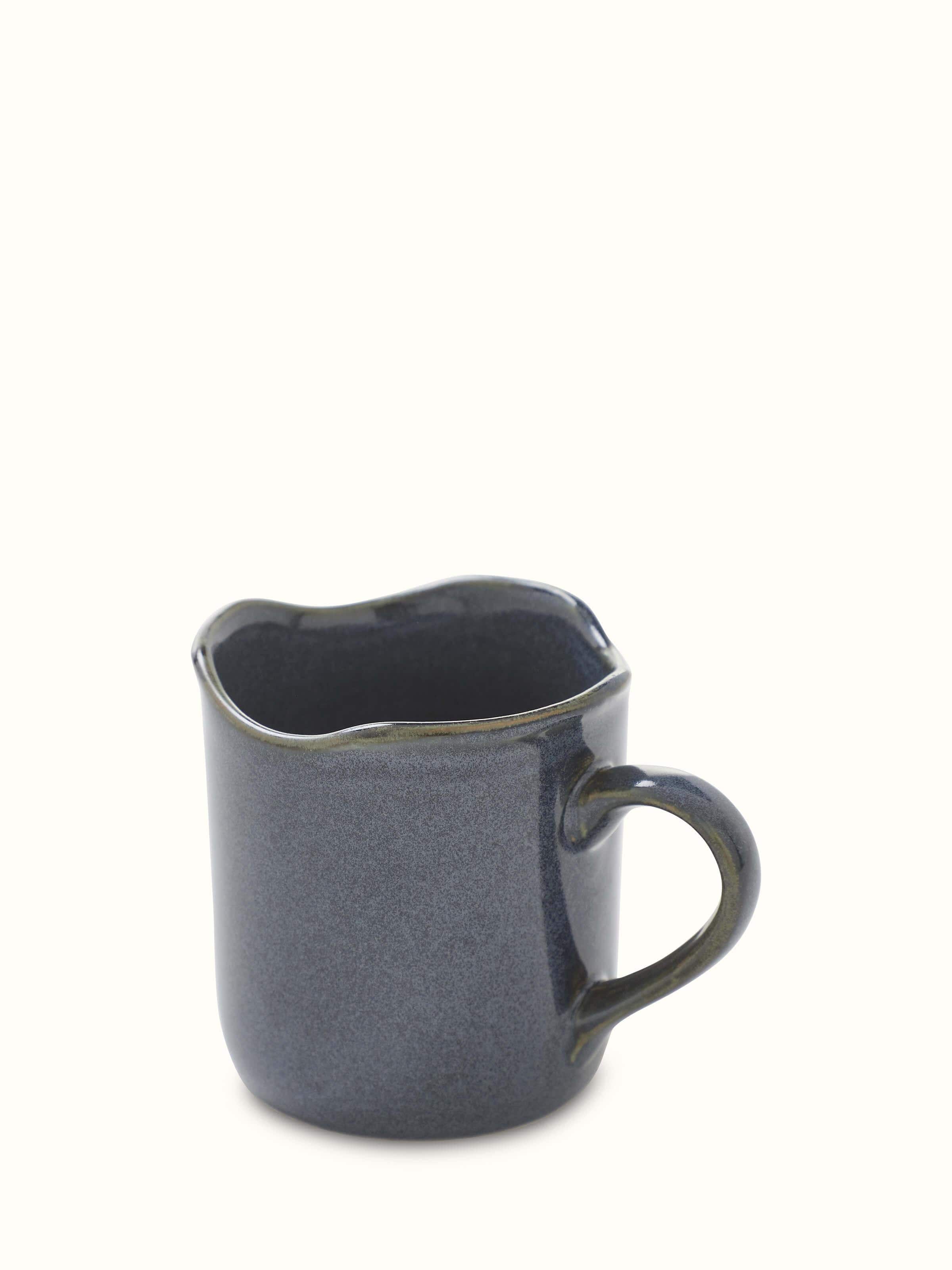 Angle view of Khurja pottery ceramic simple coffee mugs in black showcasing its modern style and functional design