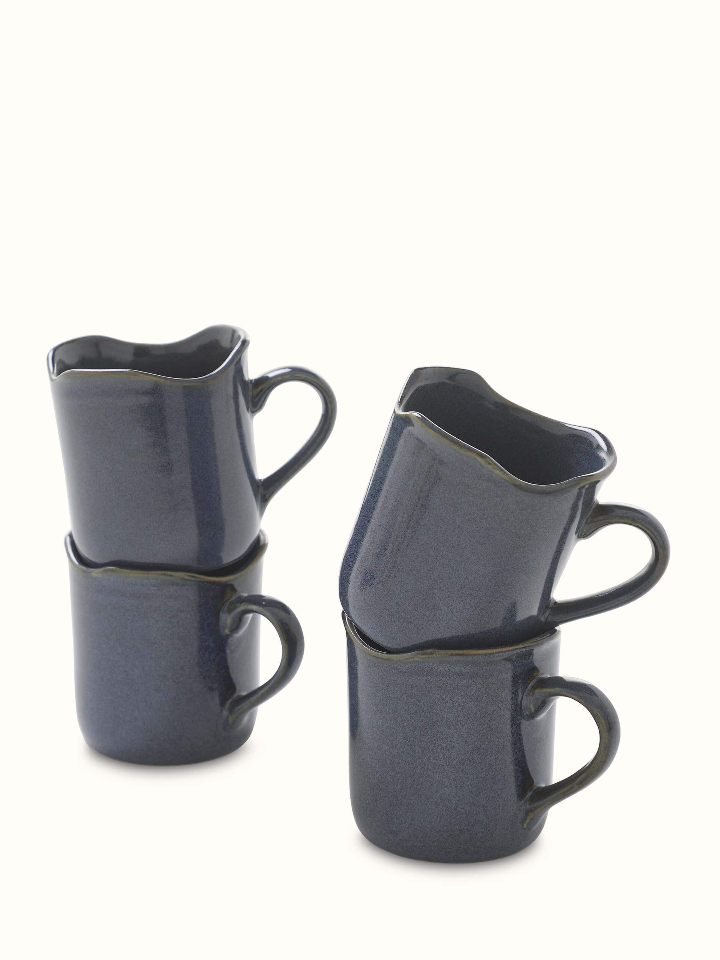 Top view of Khurja pottery ceramic simple coffee mugs in black highlighting the smooth rim and clean design