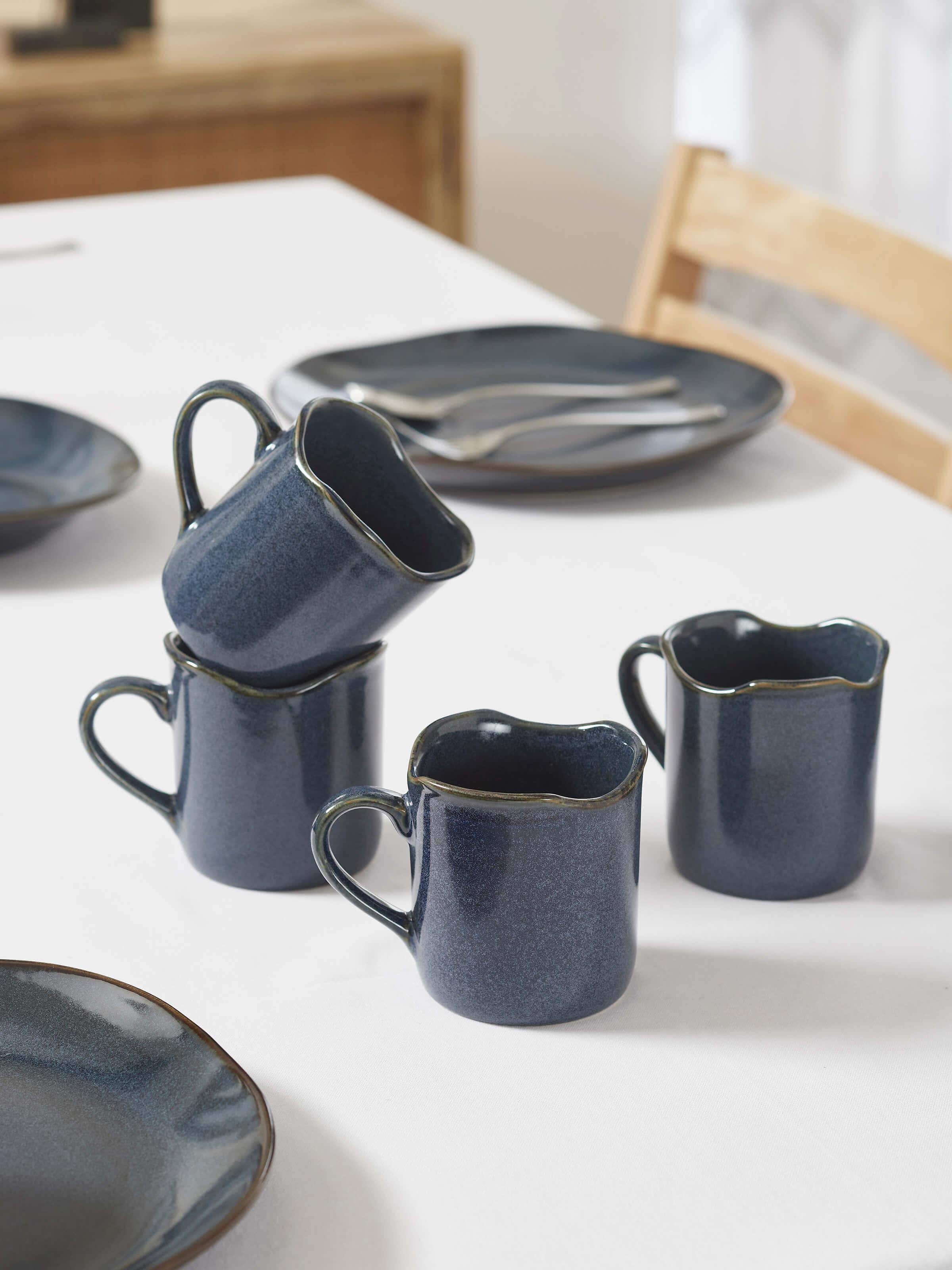 Side view of Khurja pottery ceramic simple coffee mugs in black highlighting the clean lines and elegant design