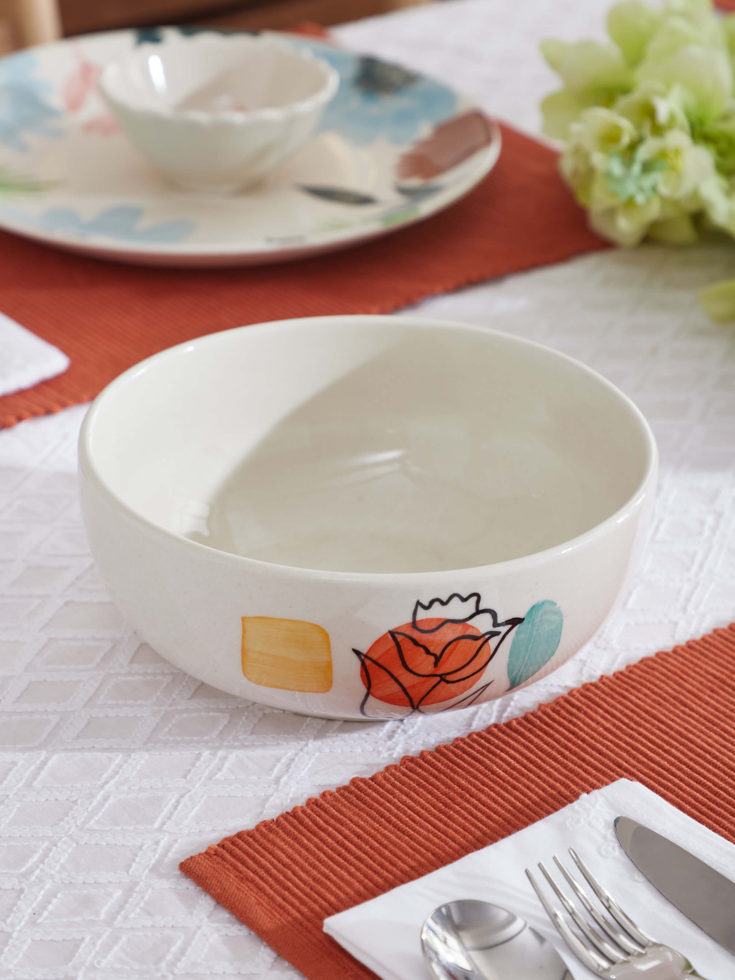 Side view of Khurja pottery ceramic serving bowl in orange & white showing detailed craftsmanship