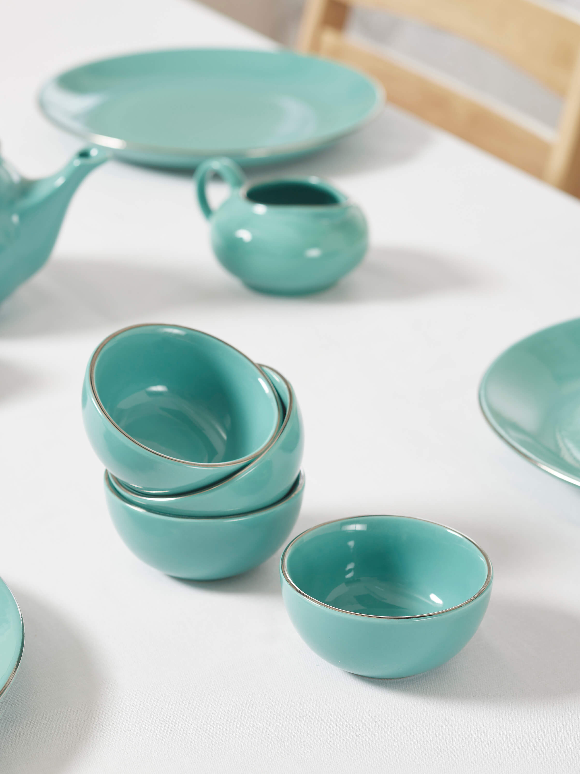 Side view of Khurja pottery ceramic dinner bowls in aqua (4 pcs) highlighting the smooth finish and stylish aqua hue