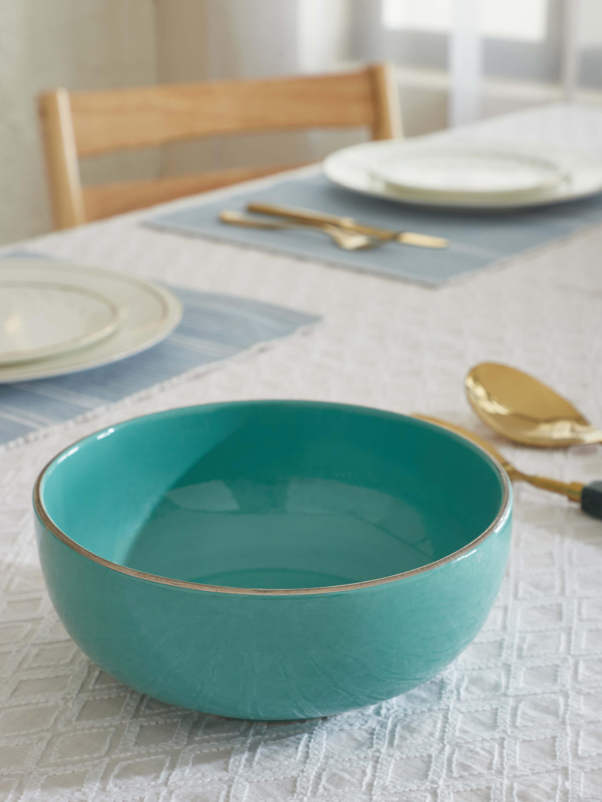 Side view of Khurja pottery ceramic serving bowl in aqua color.