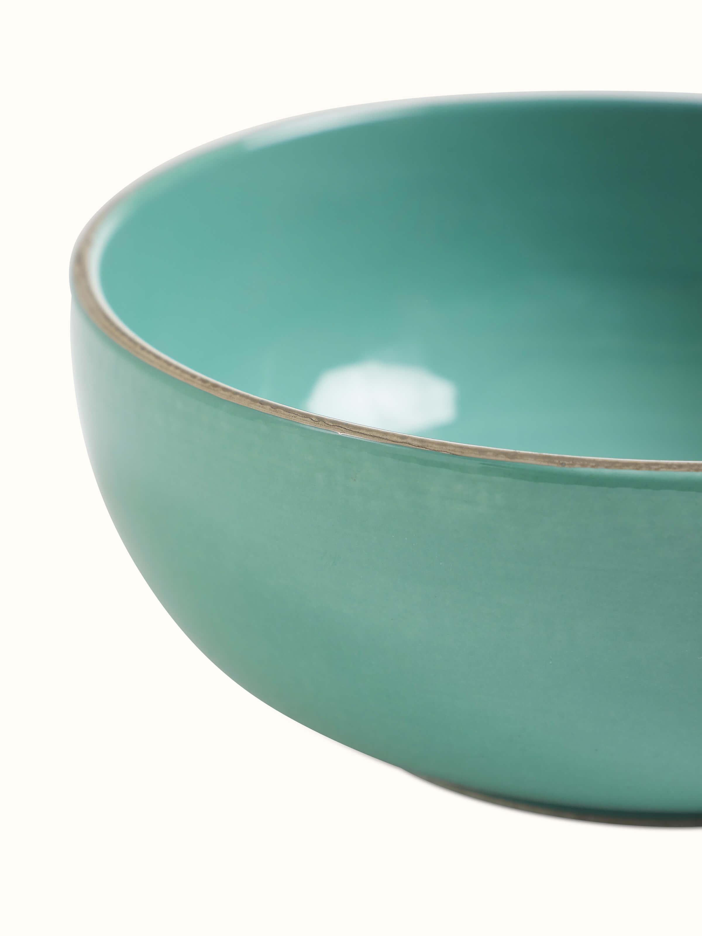Angle view of Khurja pottery ceramic serving bowl in aqua color.