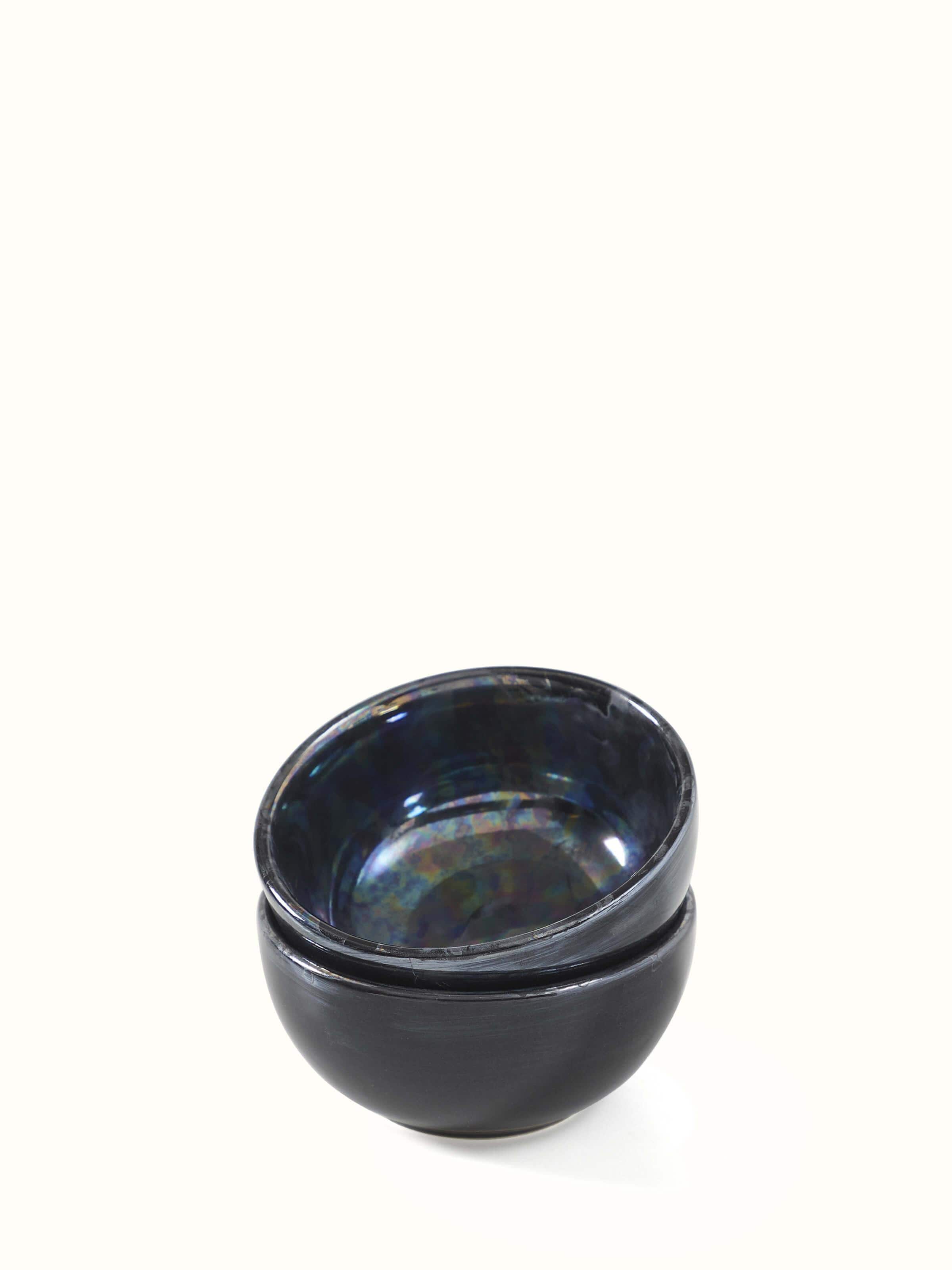 Angled view of black Khurja pottery ceramic dinner bowls, set of 4, emphasizing the classic handcrafted look.