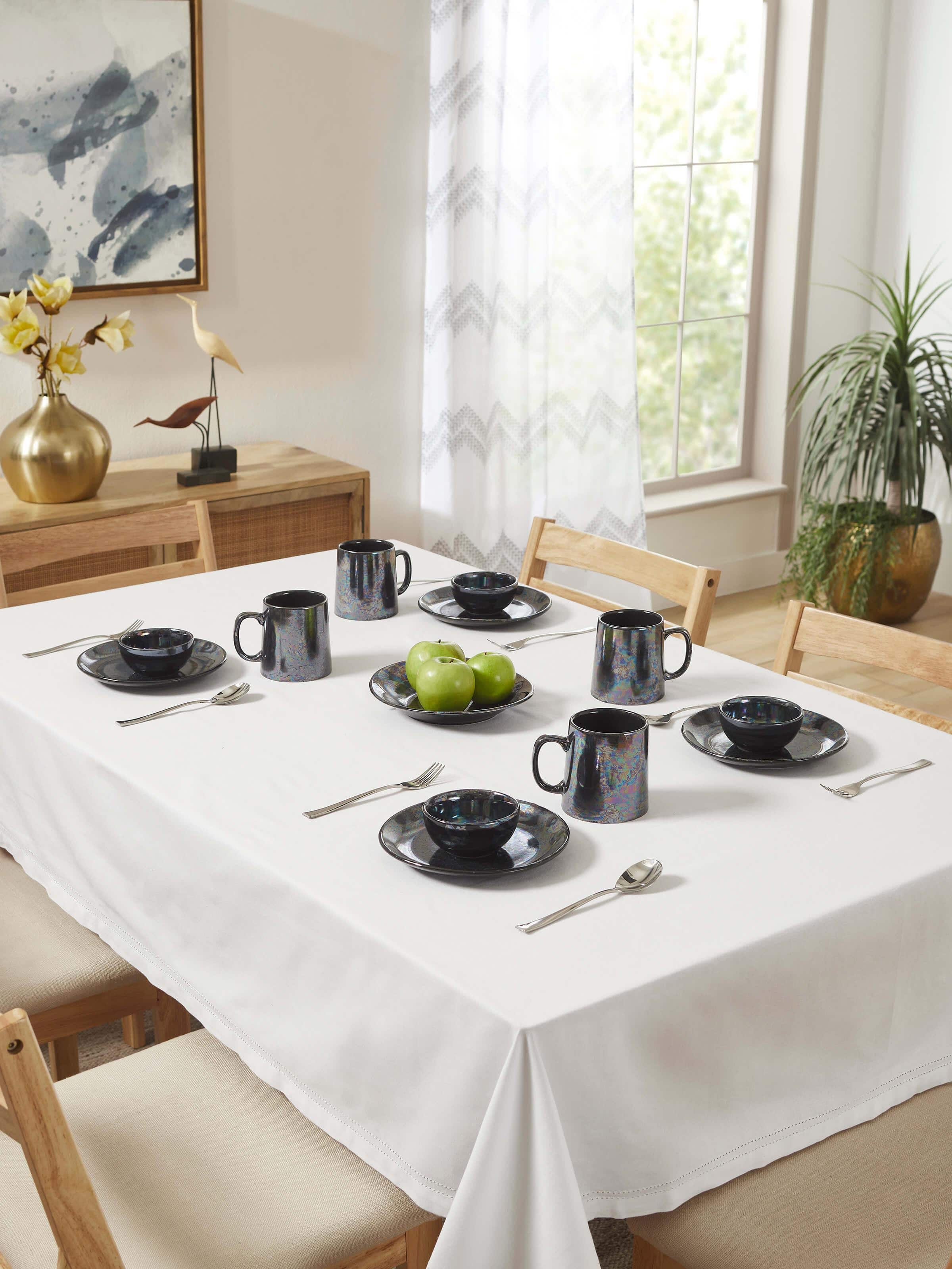 Close-up view of black Khurja pottery ceramic dinner bowls, focusing on the smooth edges and detailed finishing.