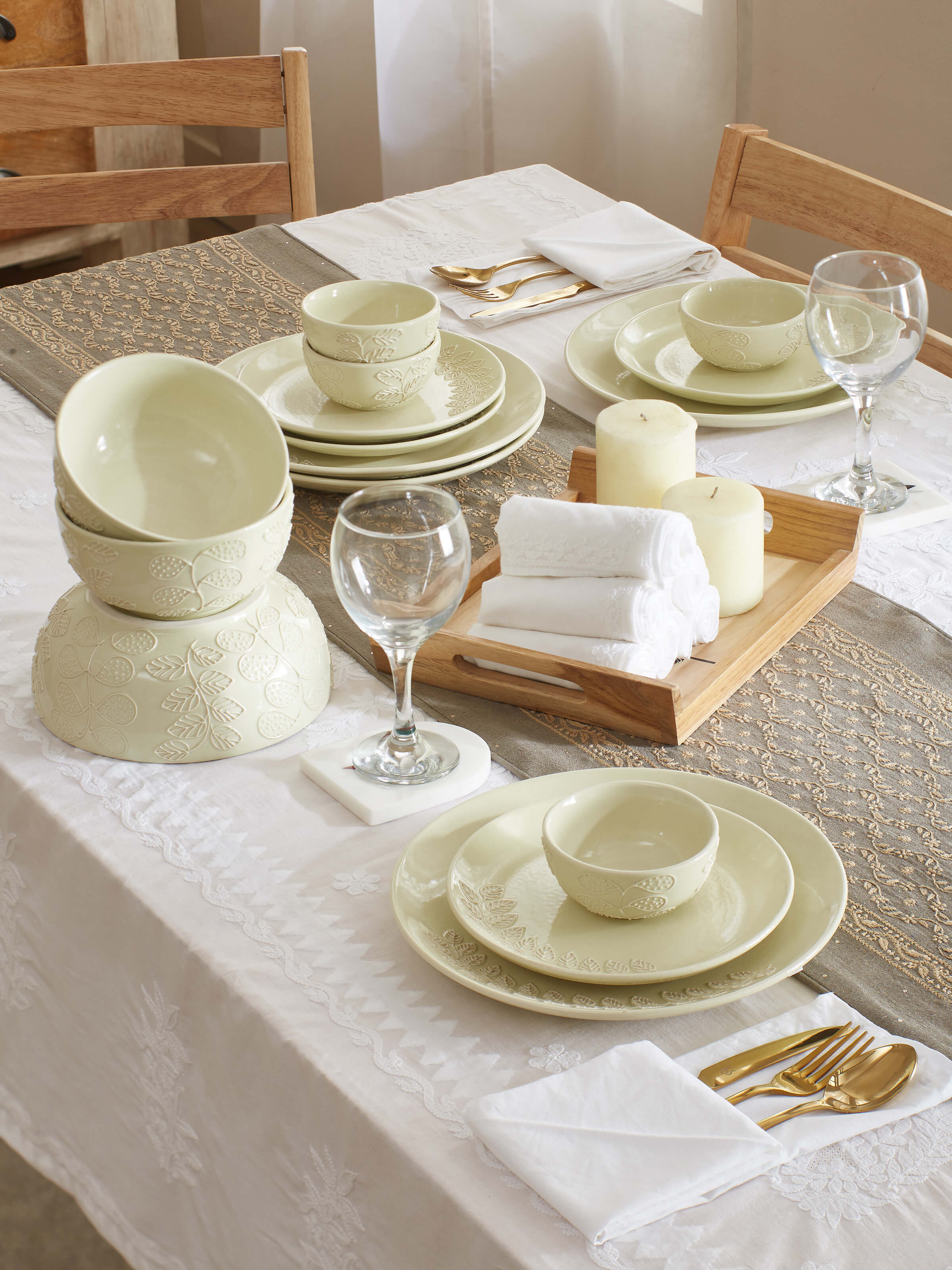 Angled view of white Khurja pottery ceramic dinner bowls, highlighting the handcrafted details.