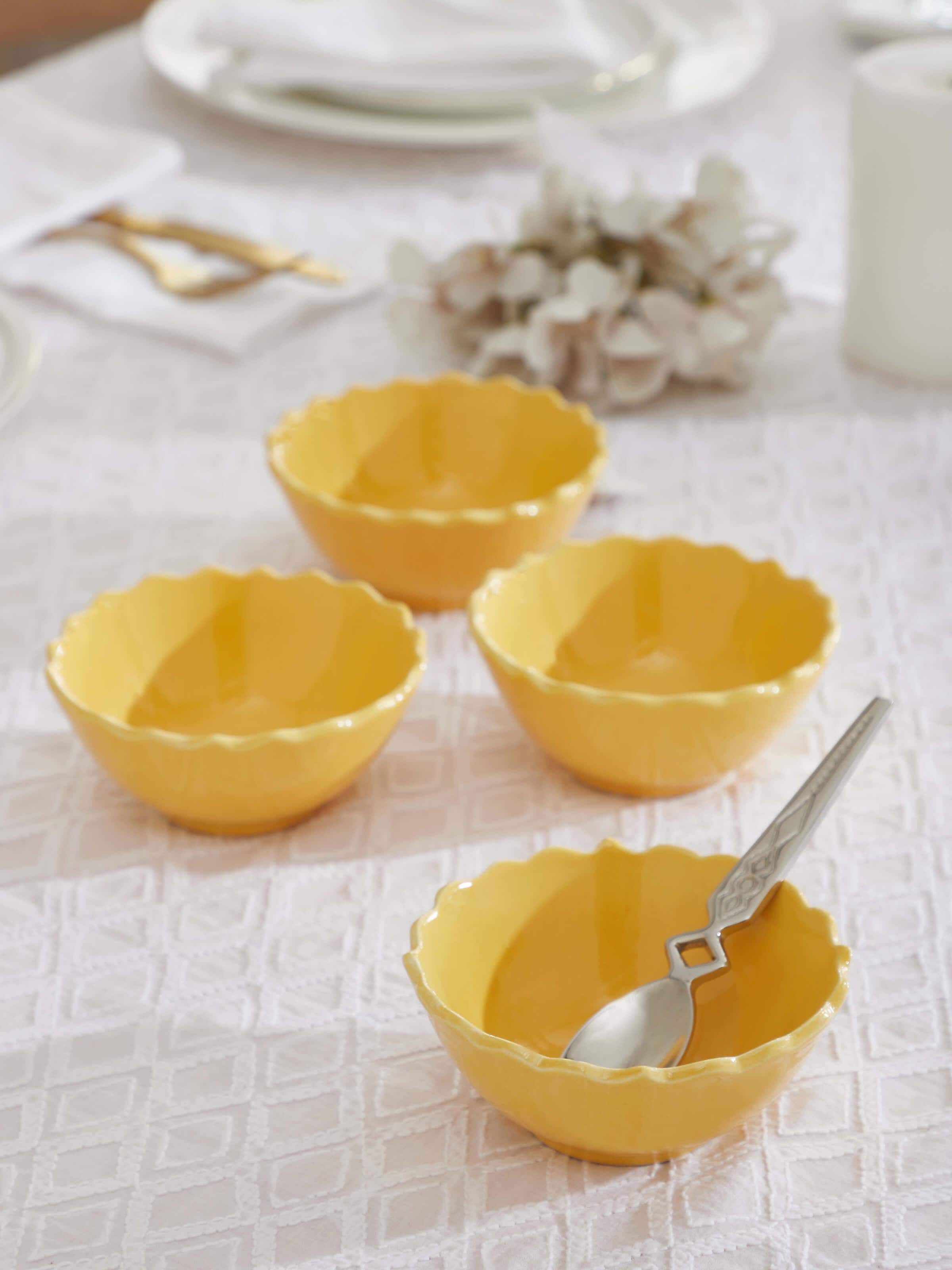 Side view of Khurja pottery ceramic dinner bowls in yellow, set of 4, highlighting the elegant curve and color.
