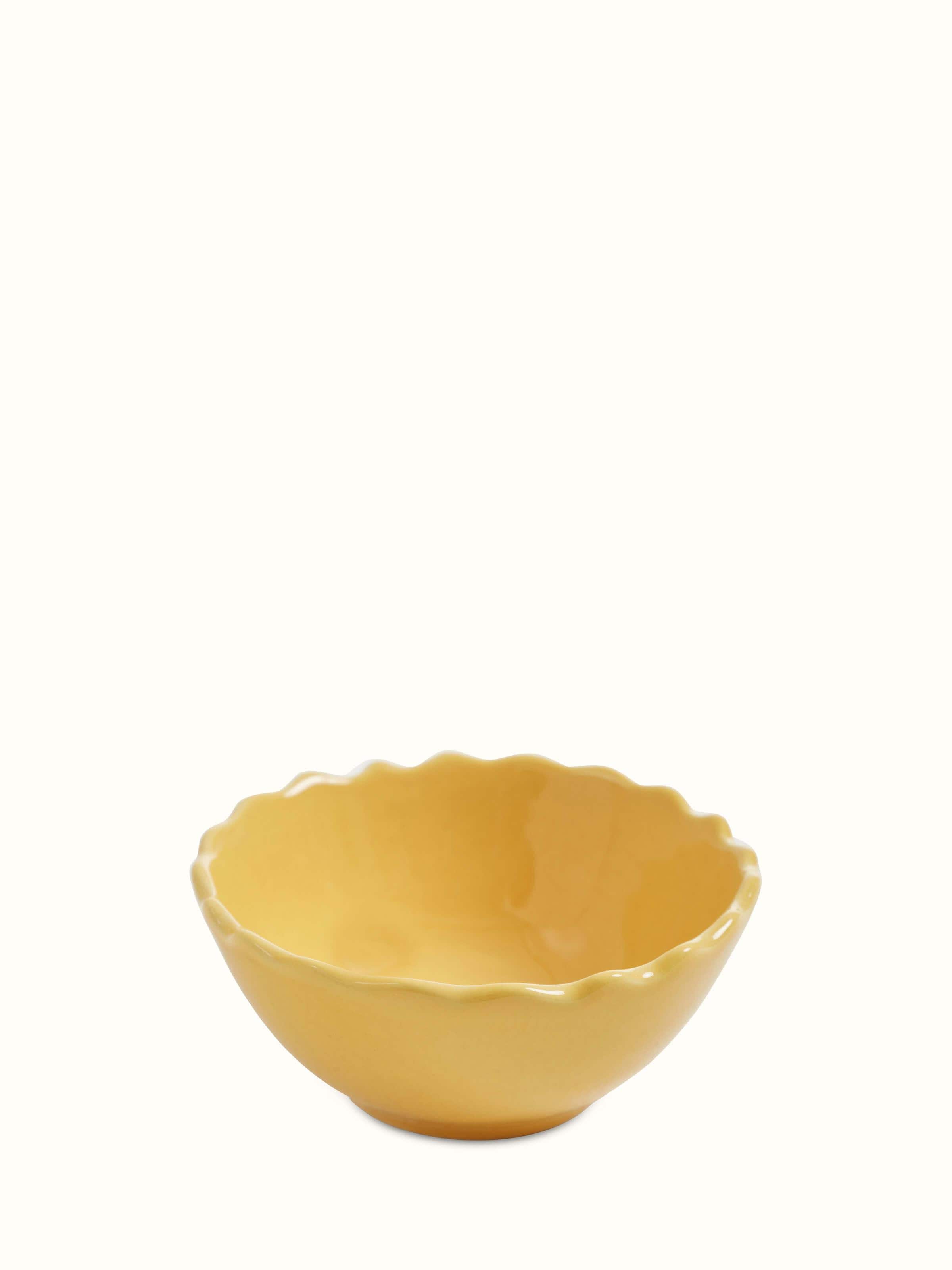 Close-up view of Khurja pottery ceramic dinner bowls in yellow, set of 4, focusing on the smooth finish and vibrant hue.