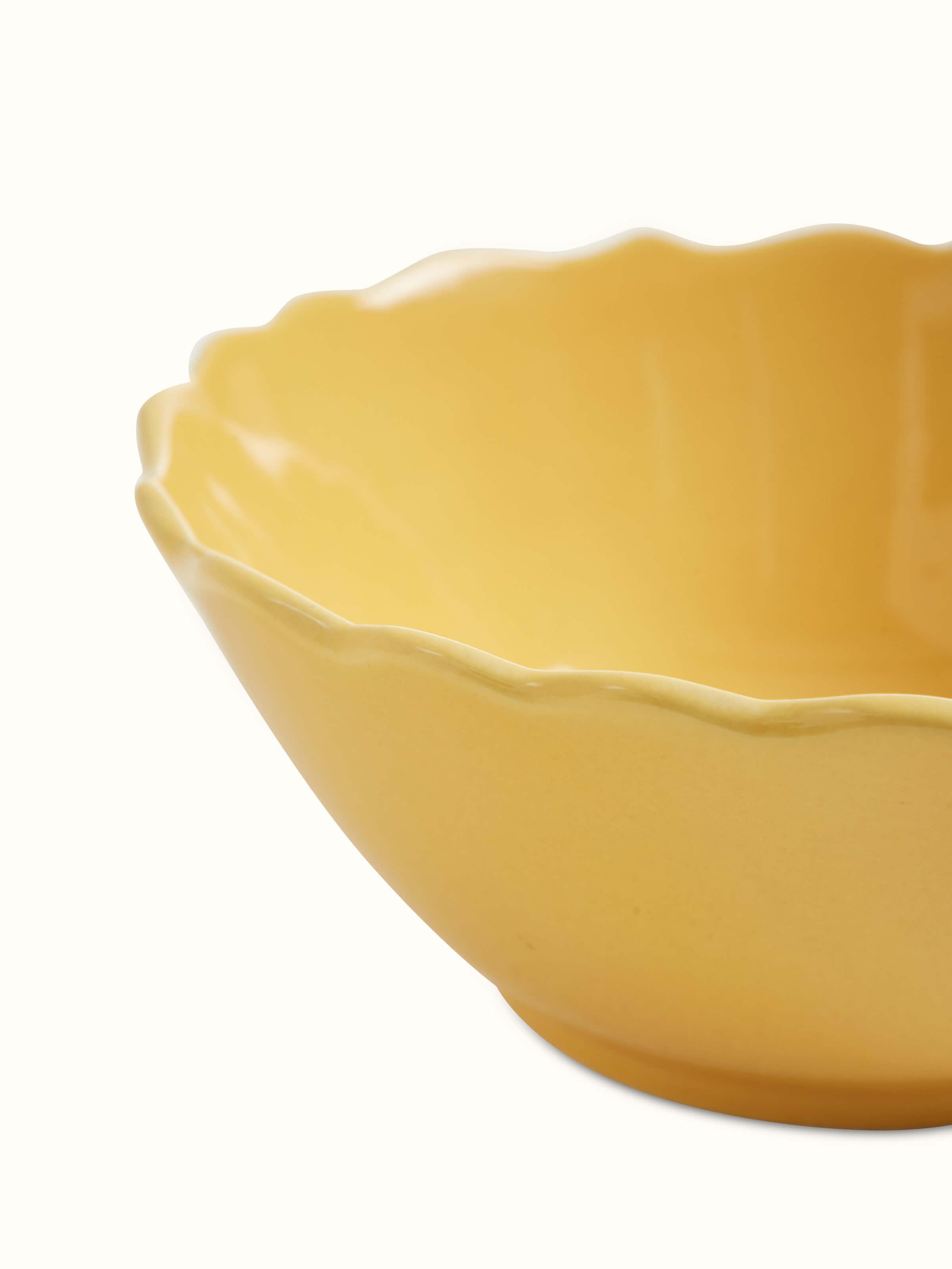 Detailed view of Khurja pottery ceramic serving bowl in yellow, focusing on the ceramic texture and finish.