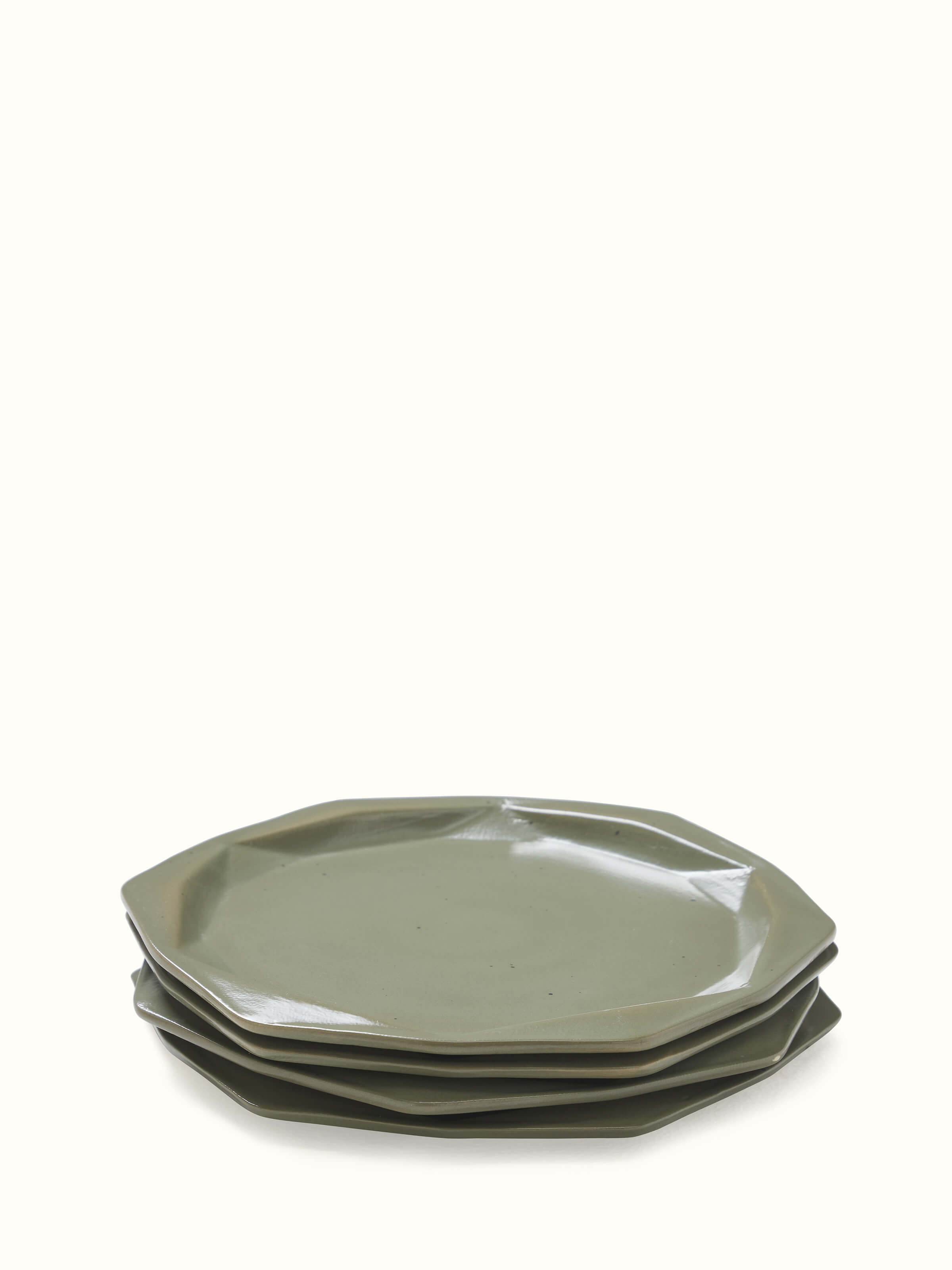 Front view of Khurja pottery ceramic dinner plates in green with a focus on the design and finish.