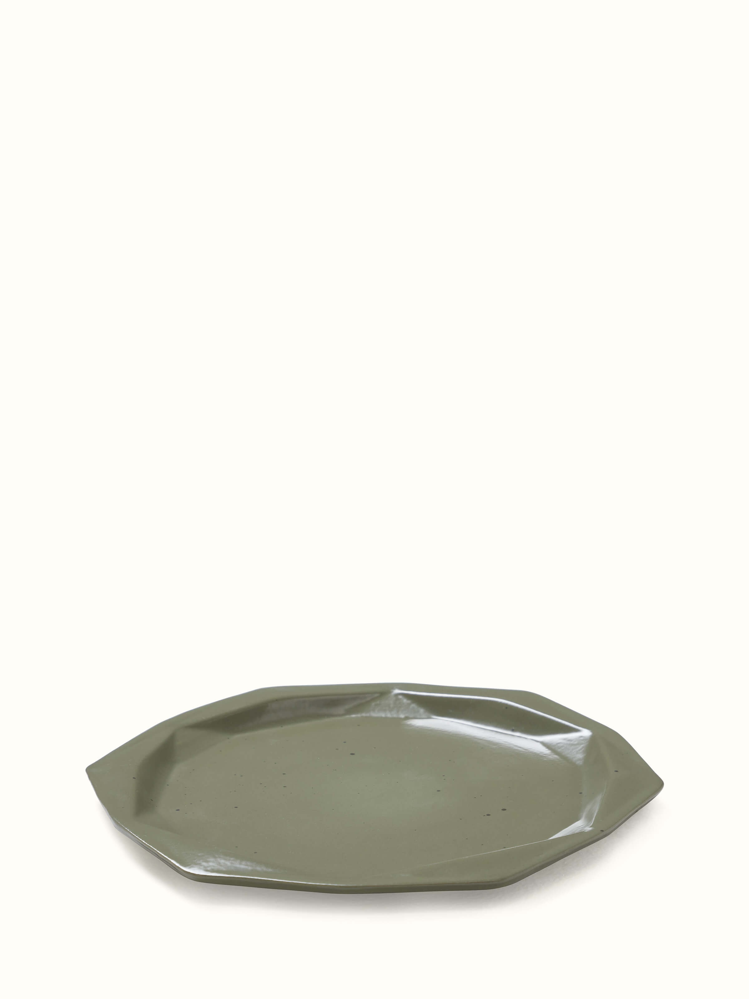 Close-up of Khurja pottery ceramic dinner plates in green emphasizing the craftsmanship and details.