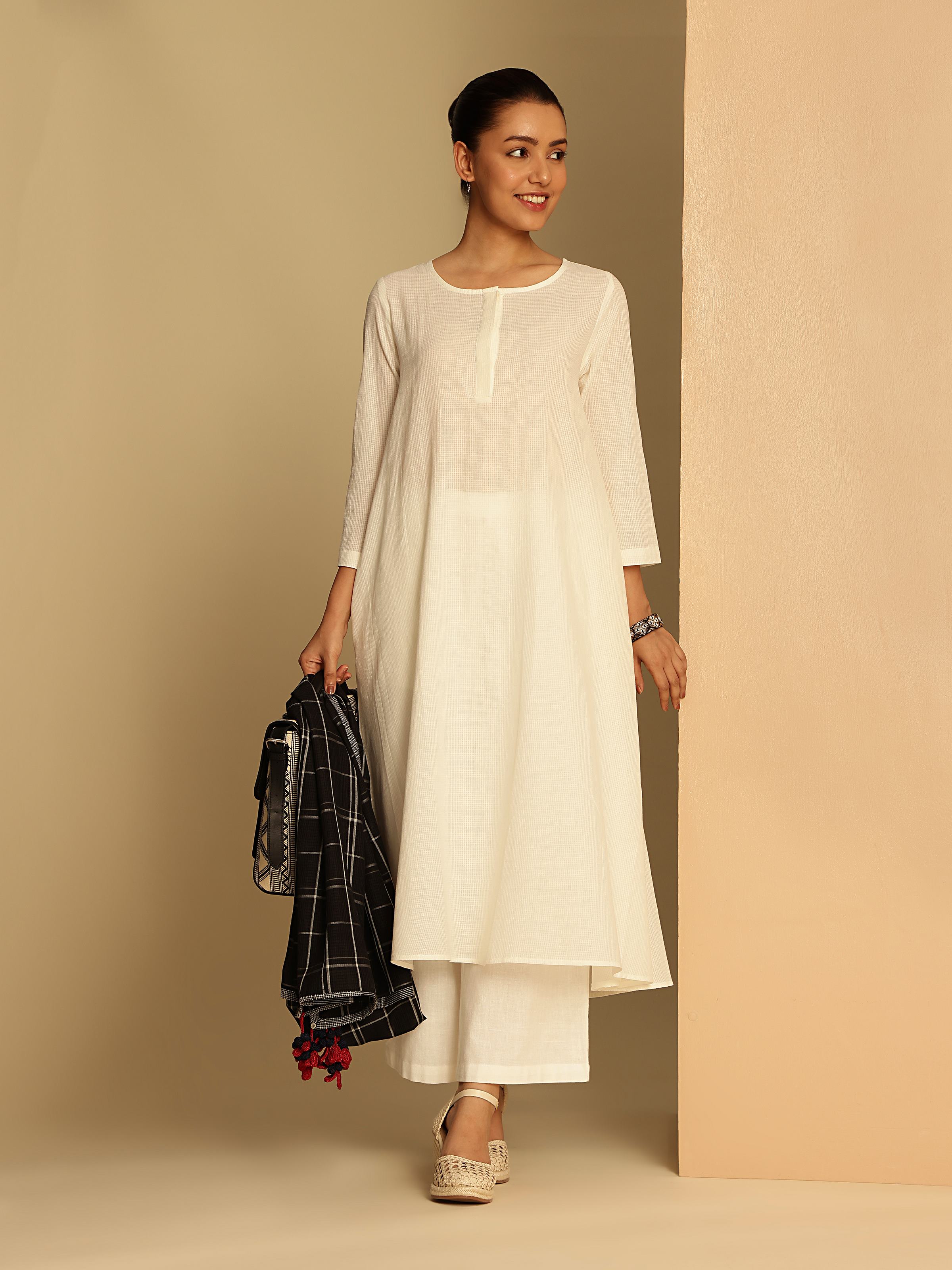Model in white long kurta styled minimally for a clean summer look.
