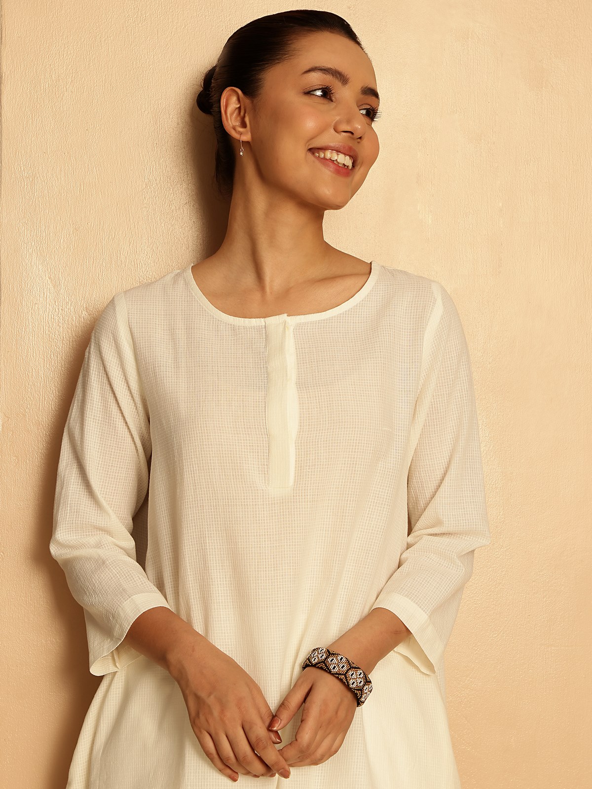 Side pose showcasing handloom texture and straight hem of kurta.