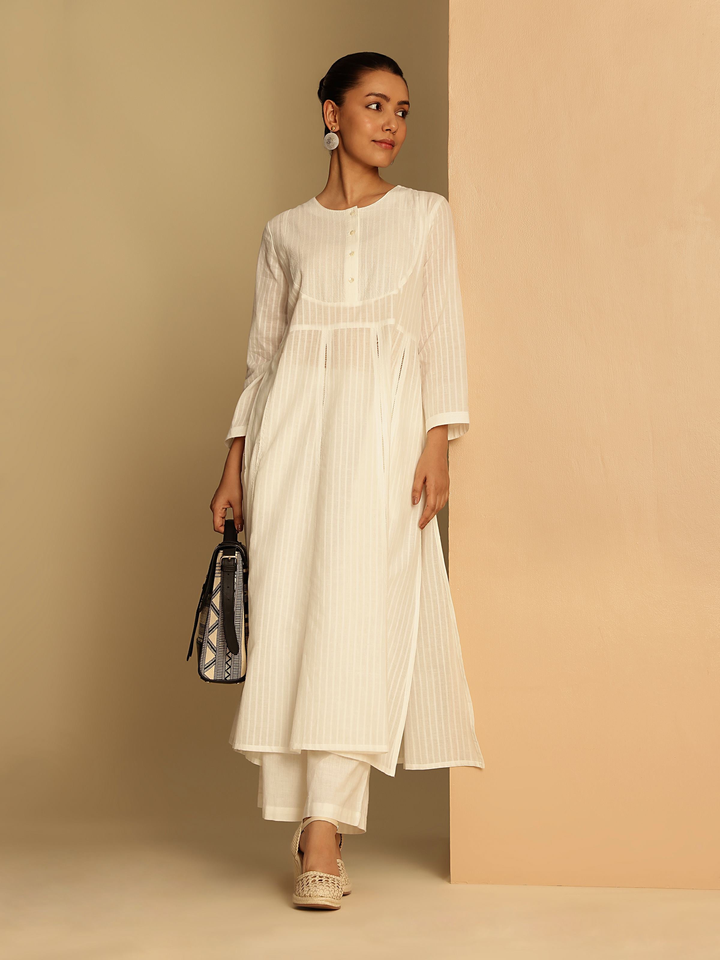 Side view of white cotton hand-spun Anarkali kurta showing flowing flare and lightweight fabric.