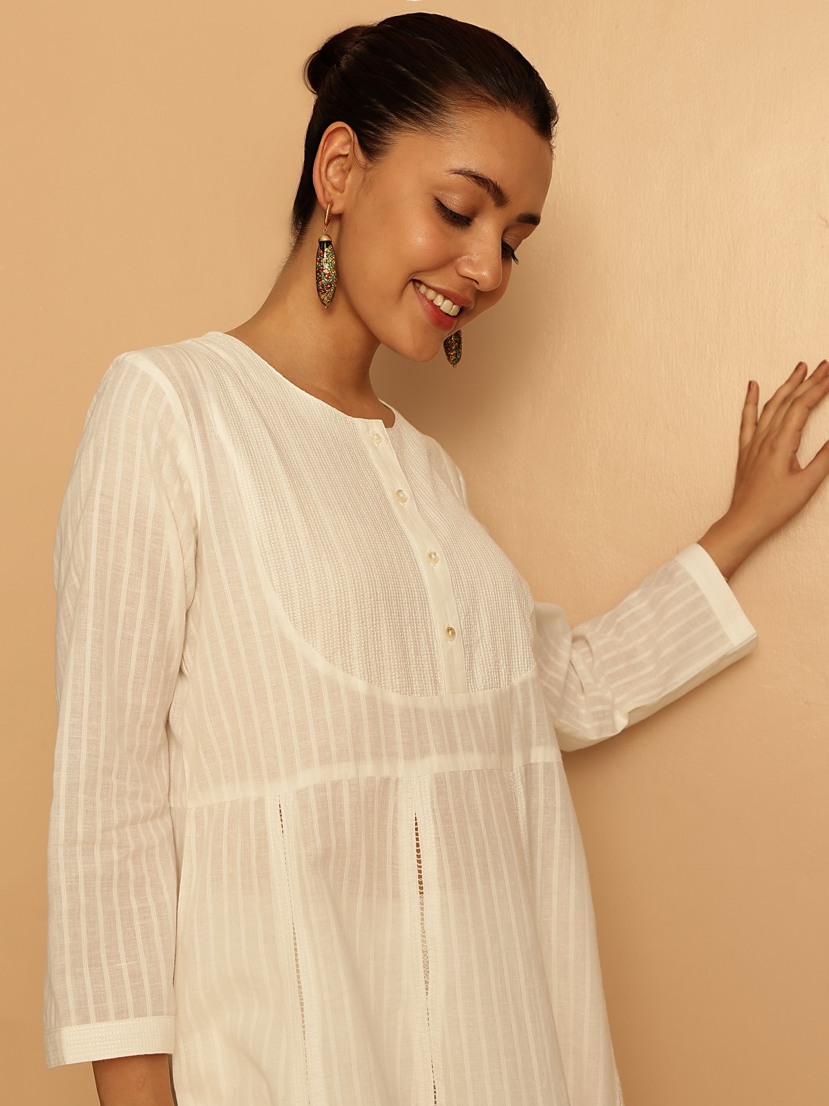 Close-up side angle of white cotton hand-spun Anarkali kurta highlighting fine fabric texture and stitching