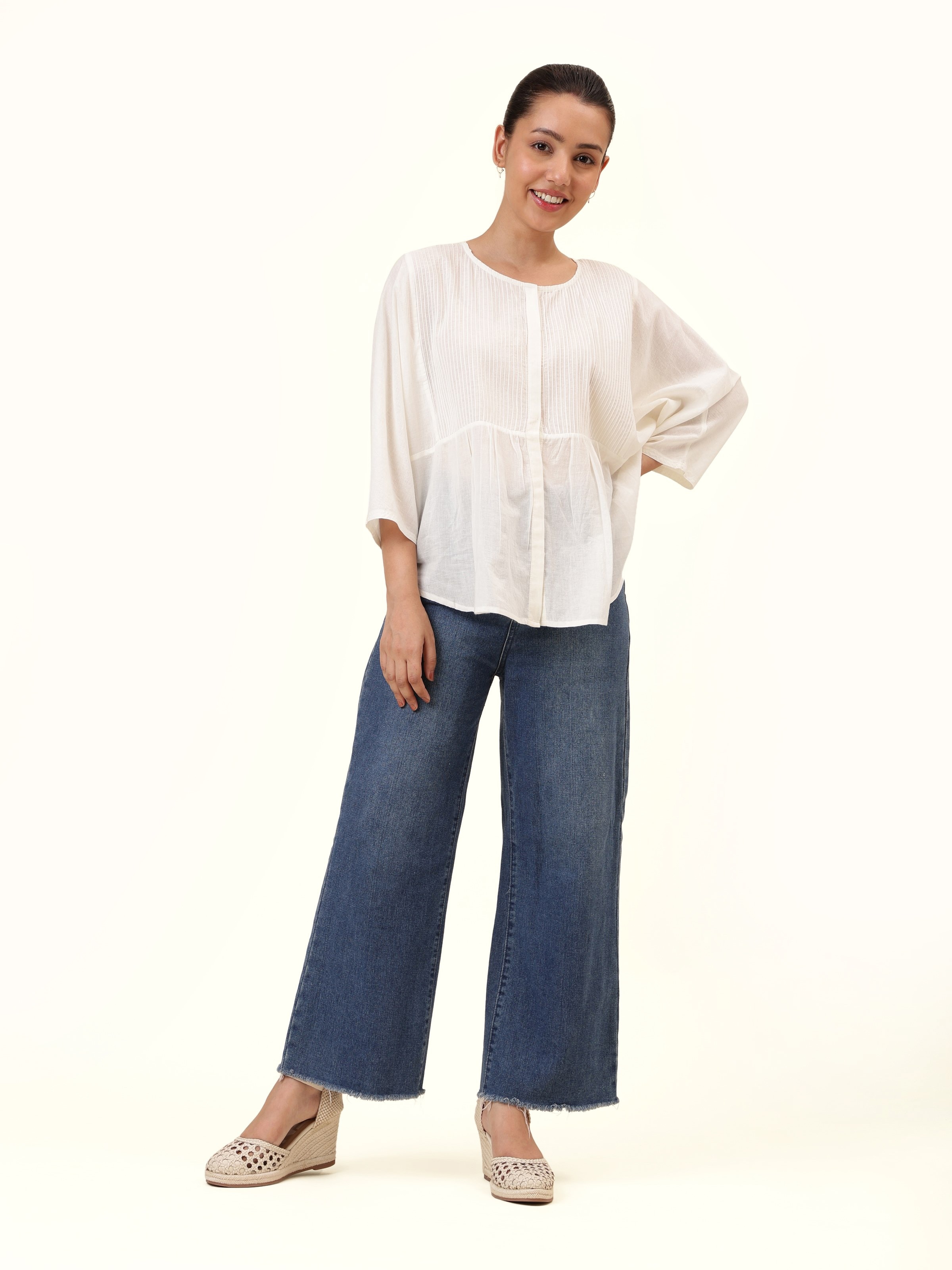 Front view of white cotton hand-spun top with simple handcrafted texture