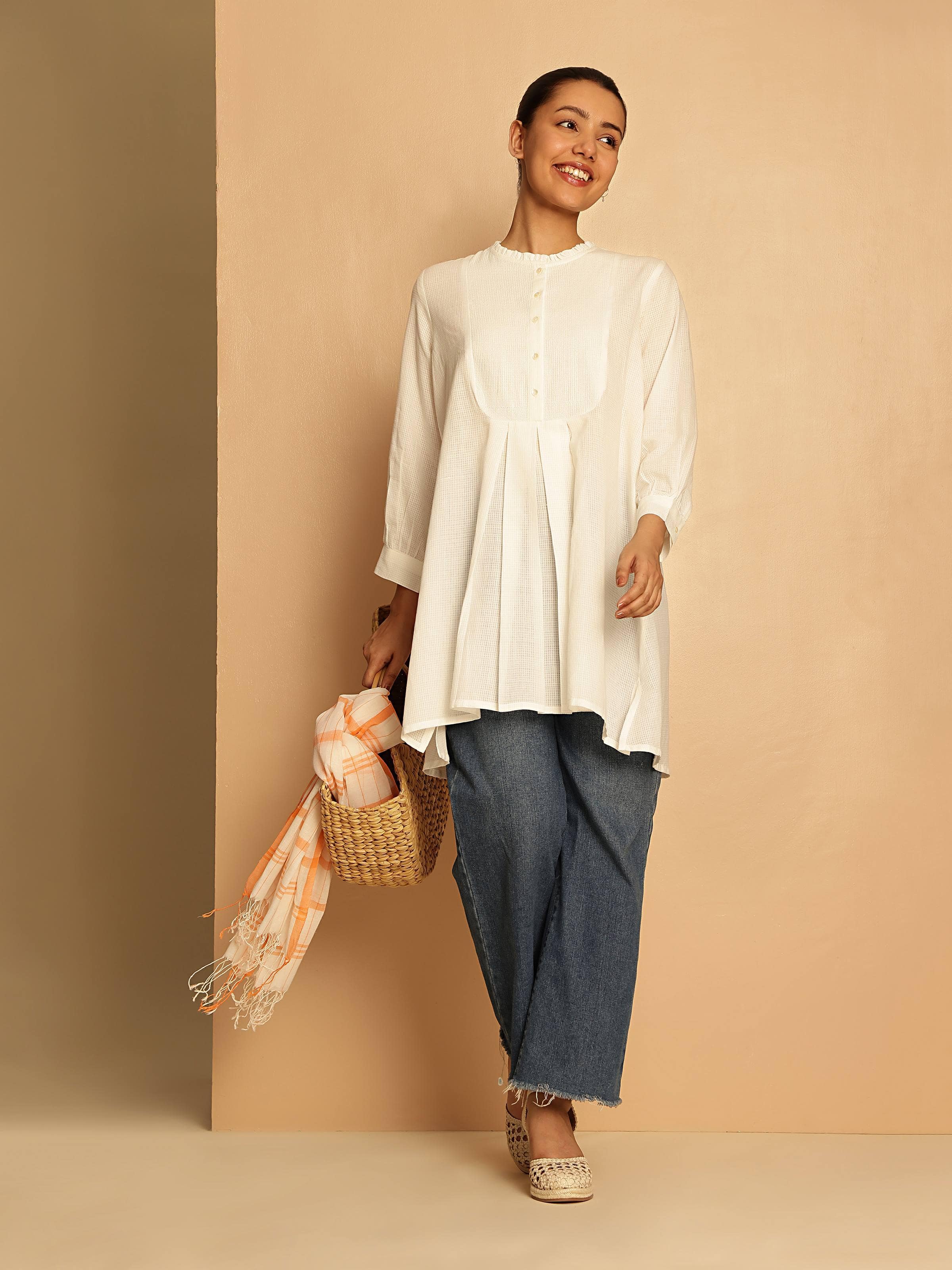 Lifestyle view of cotton tunic styled with earthy trousers for relaxed fit