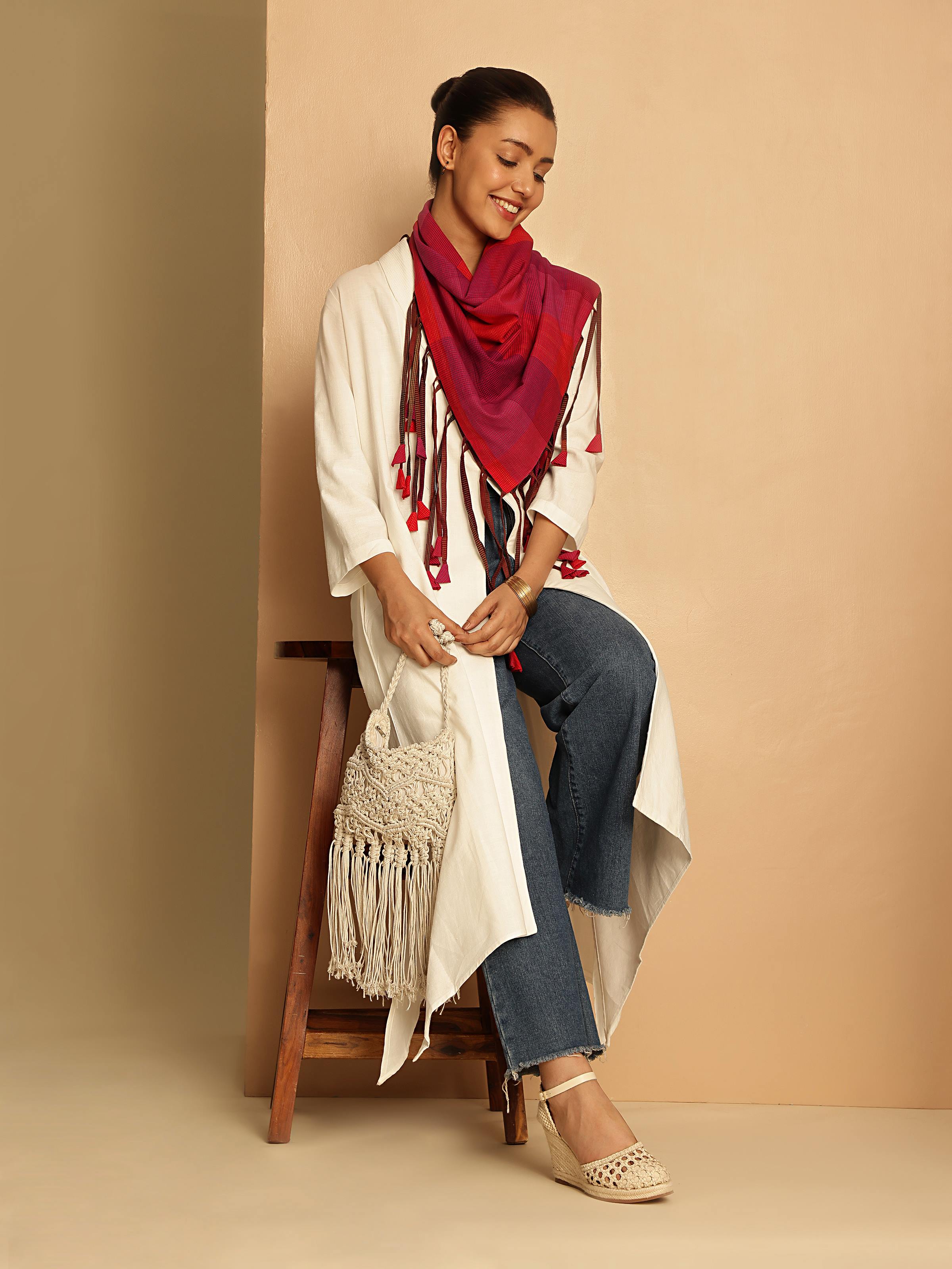 Side lifestyle view of white cotton jacket showing structured silhouette and sleeves.