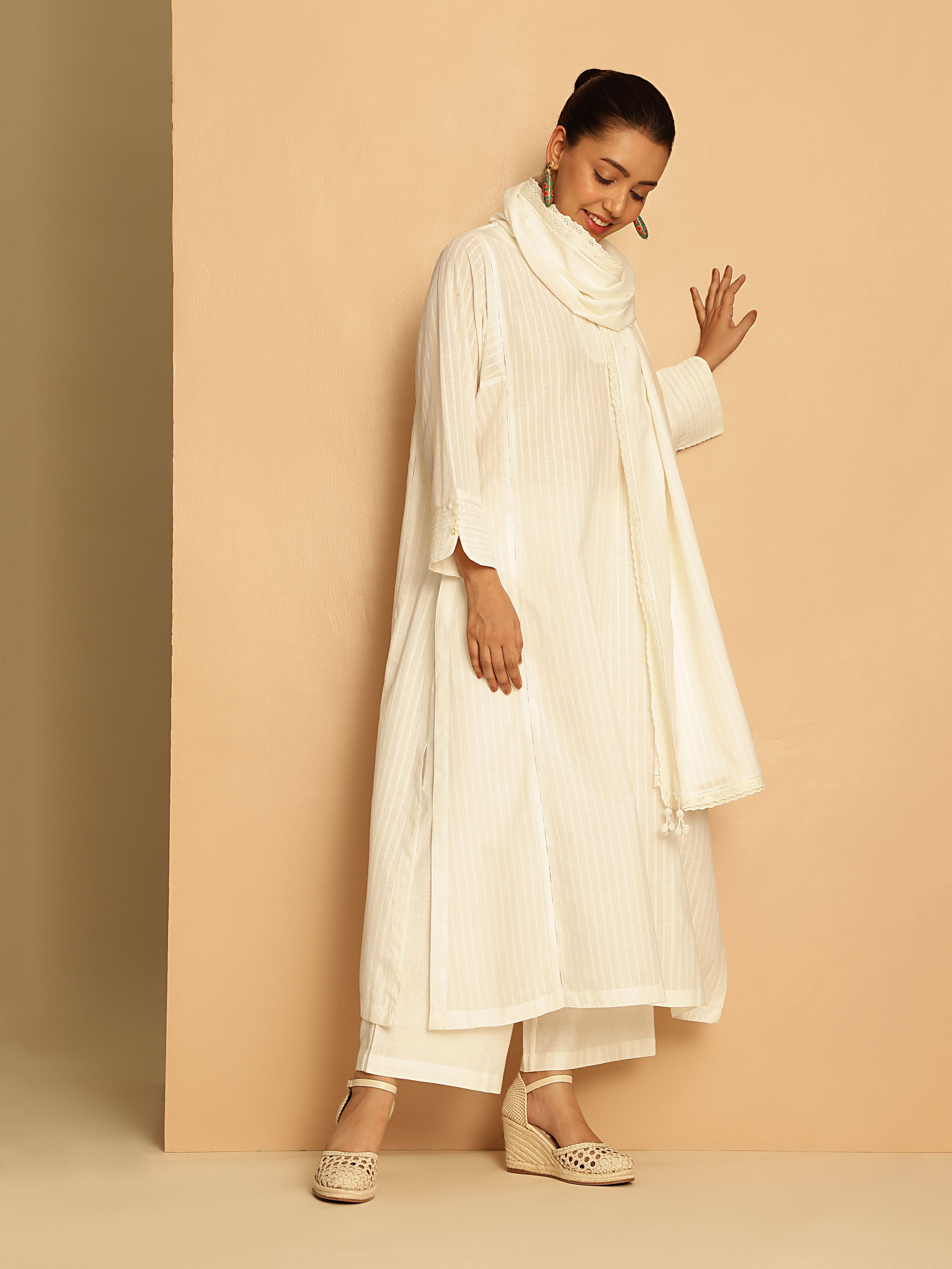 Lifestyle view of White Cotton Hand-spun Long Kurta with Pleated Cuff worn casually highlighting soft cotton fabric