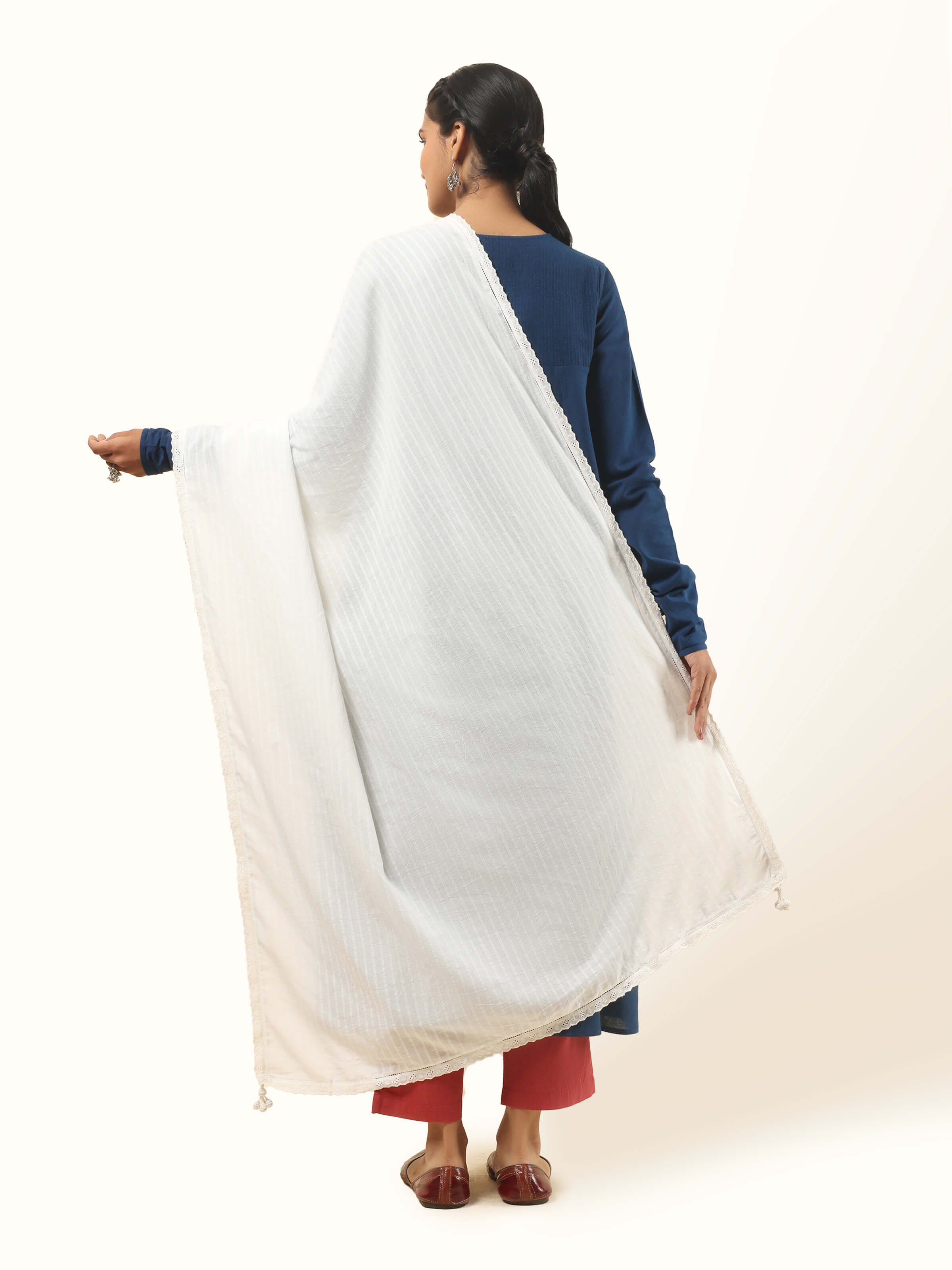 Back view of white cotton dupatta on model, capturing the soft flow and handcrafted look.