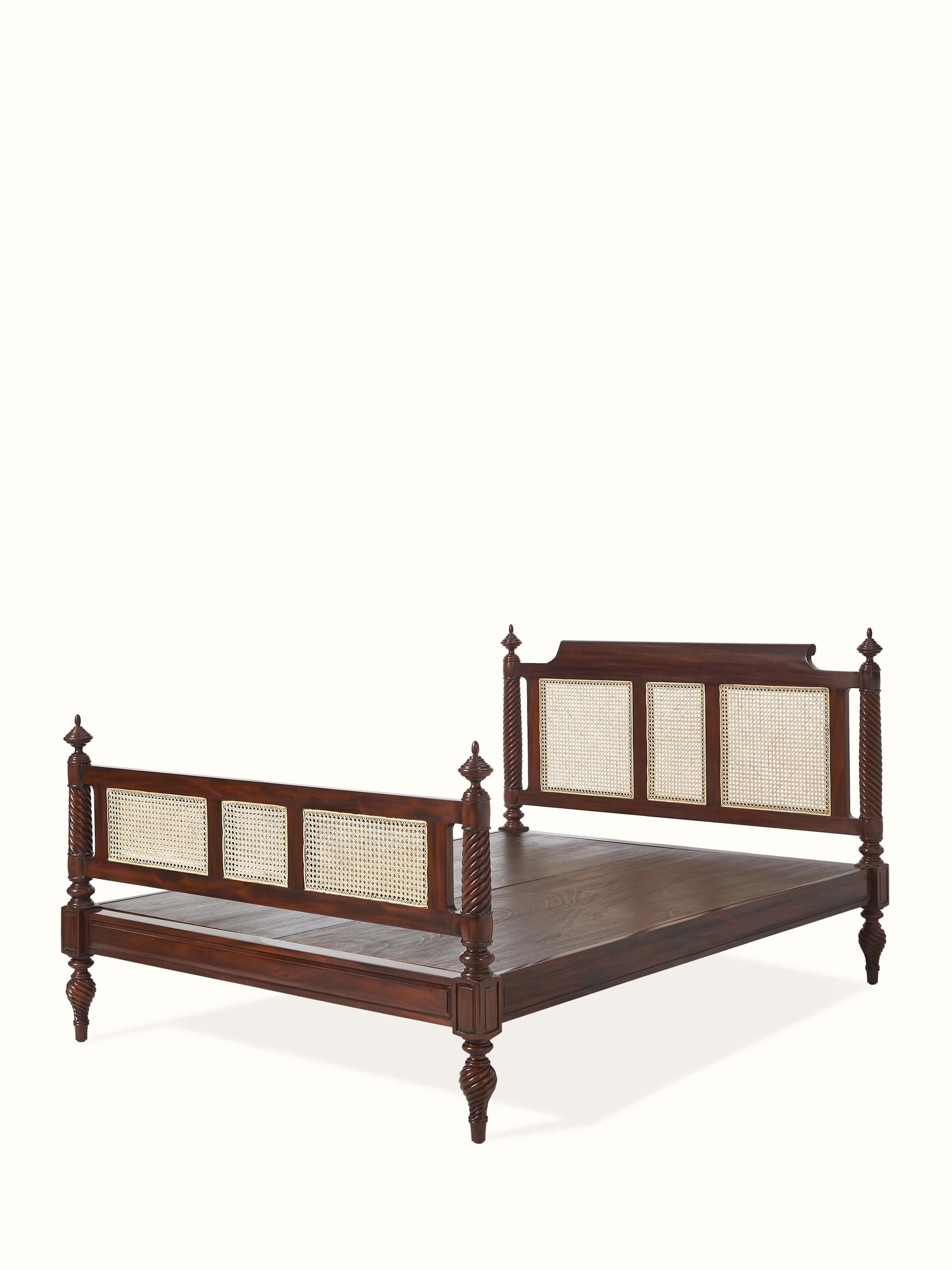 Side view of the carved mahogany wood and cane queen bed, highlighting the detailed woodwork and cane detailing.