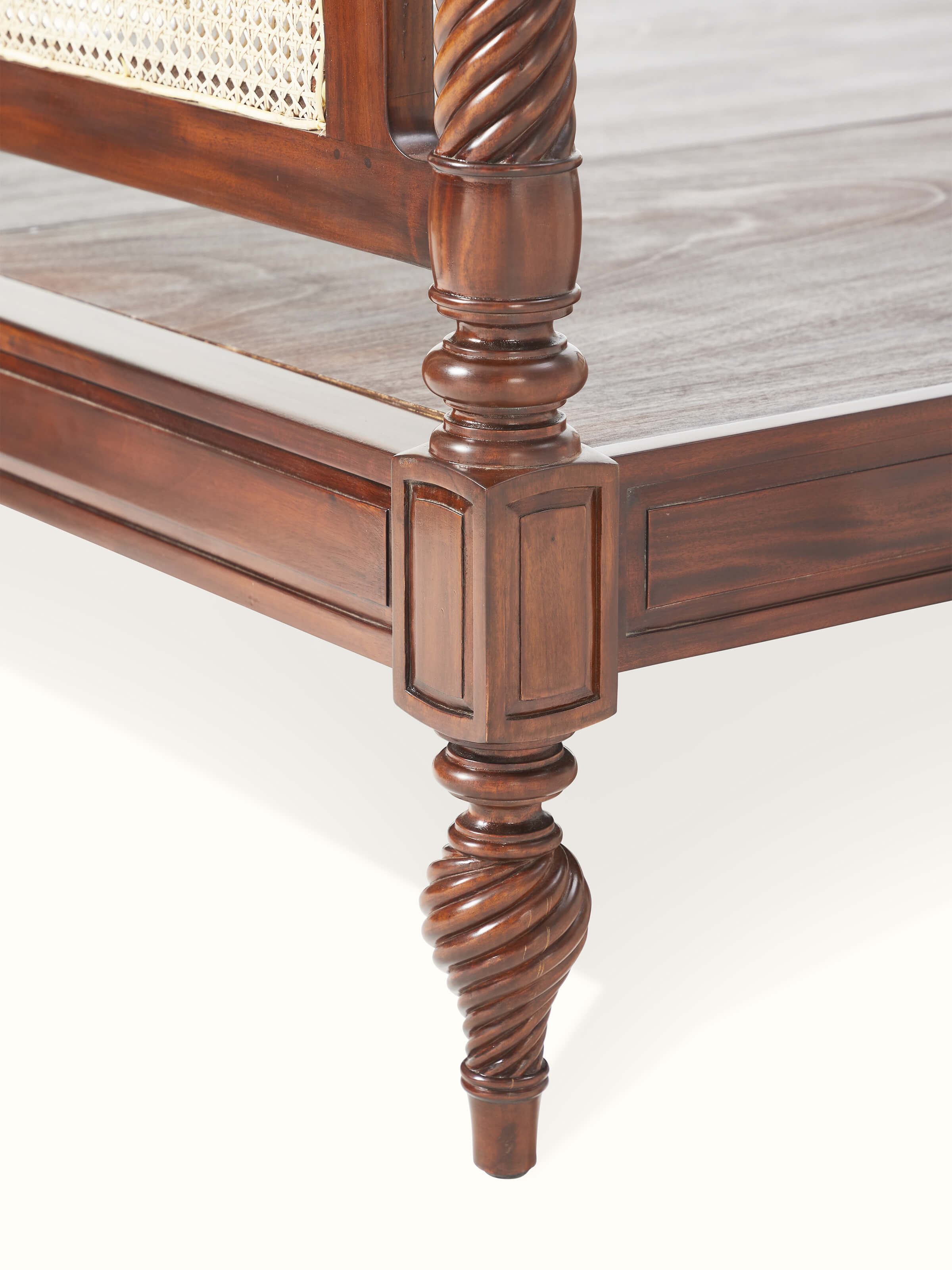 Overall view of the mahogany wood and cane queen bed, displaying the bed's full structure and elegant woodwork.