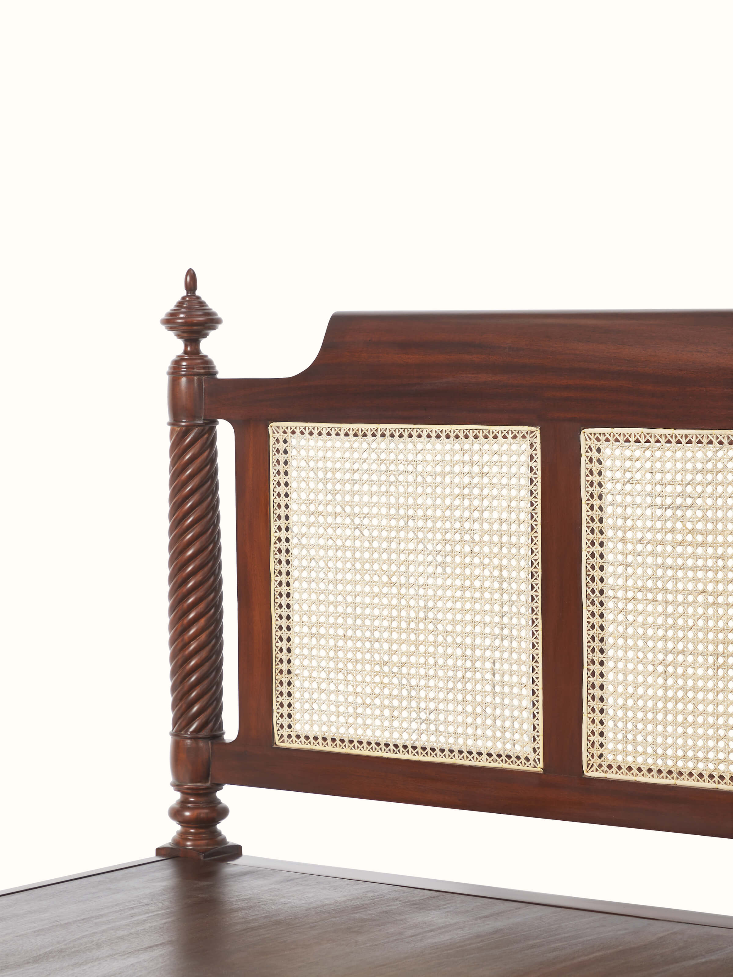 Top-down view of the queen size bed, highlighting the carving details and the blend of mahogany wood with cane elements.