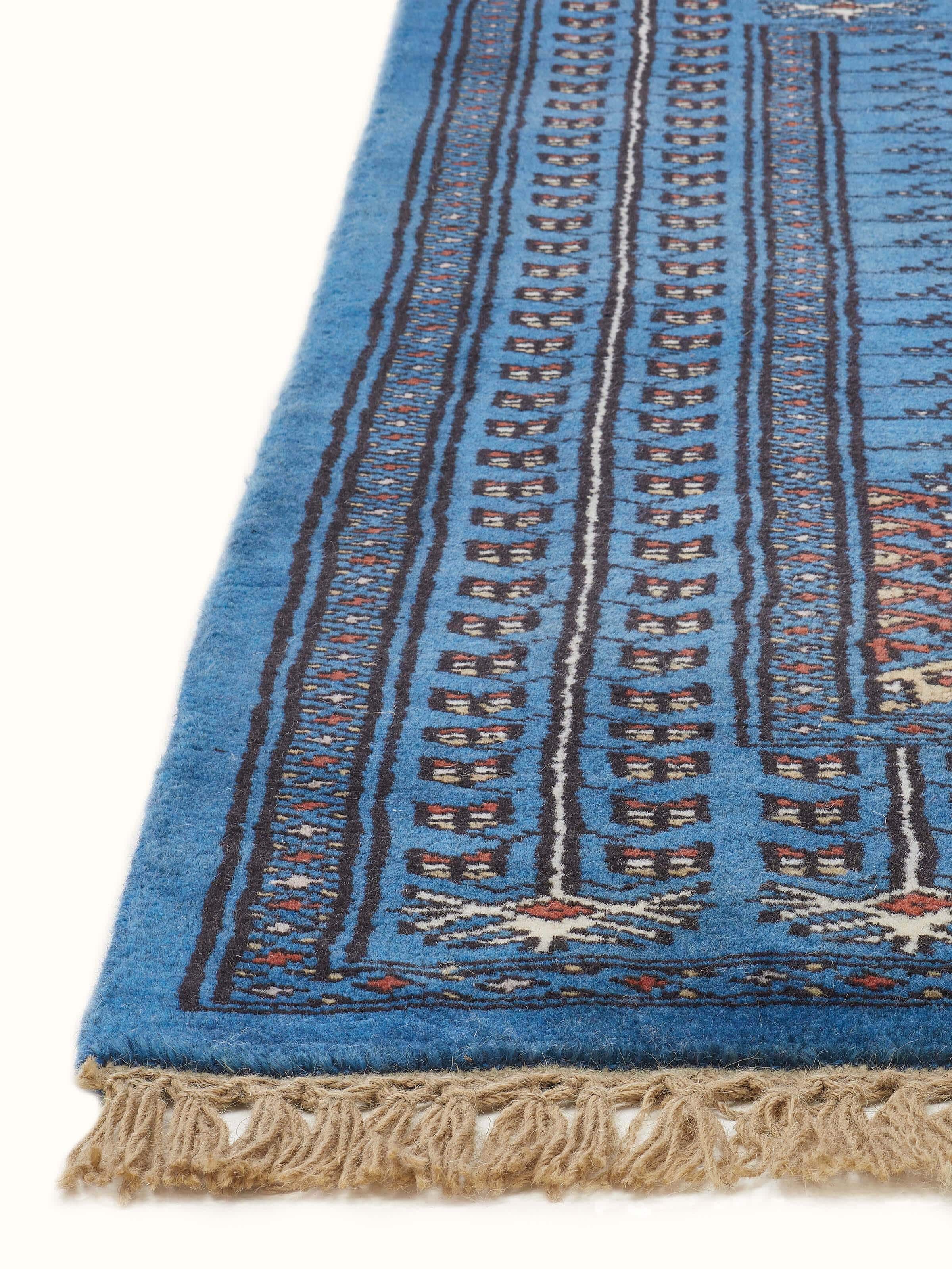 Side view of the Amritsari parda blue Gwalior wool hand-knotted runner, showing the full length and design.
