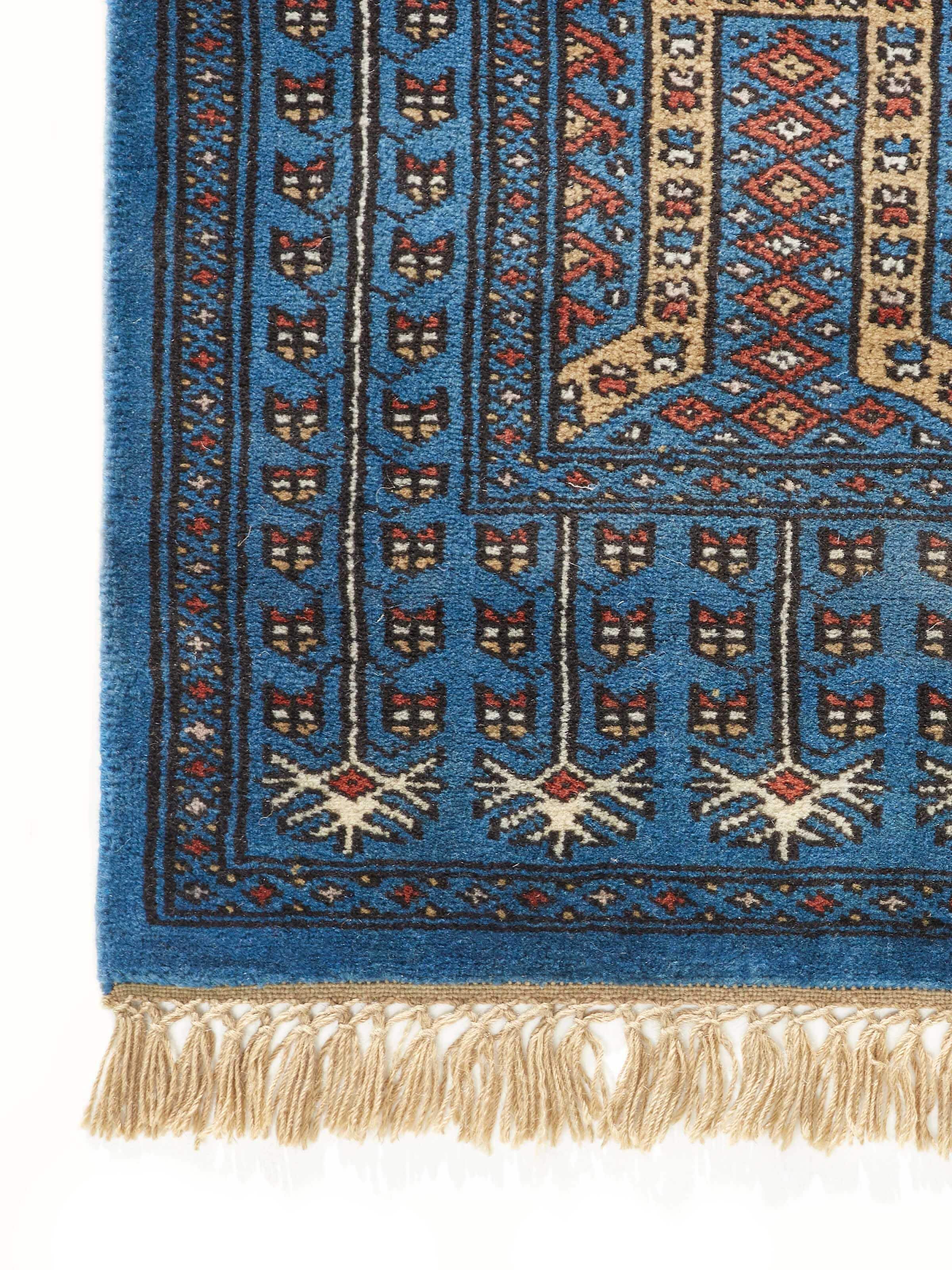 Detailed view of the Amritsari parda blue Gwalior wool hand-knotted runner, emphasizing the craftsmanship and colors.