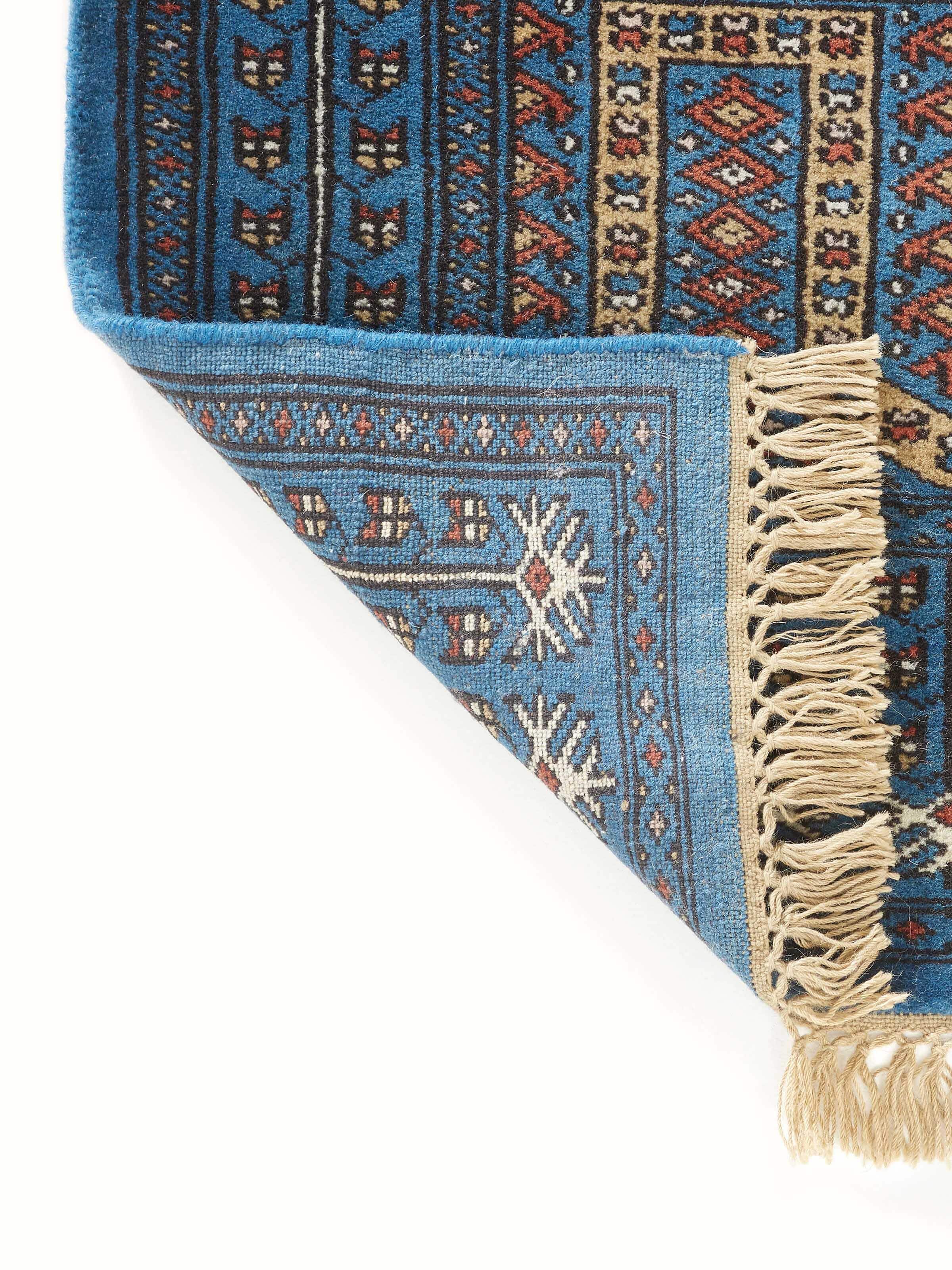 Full view of the Amritsari parda blue Gwalior wool hand-knotted runner, highlighting its use in a room setting.