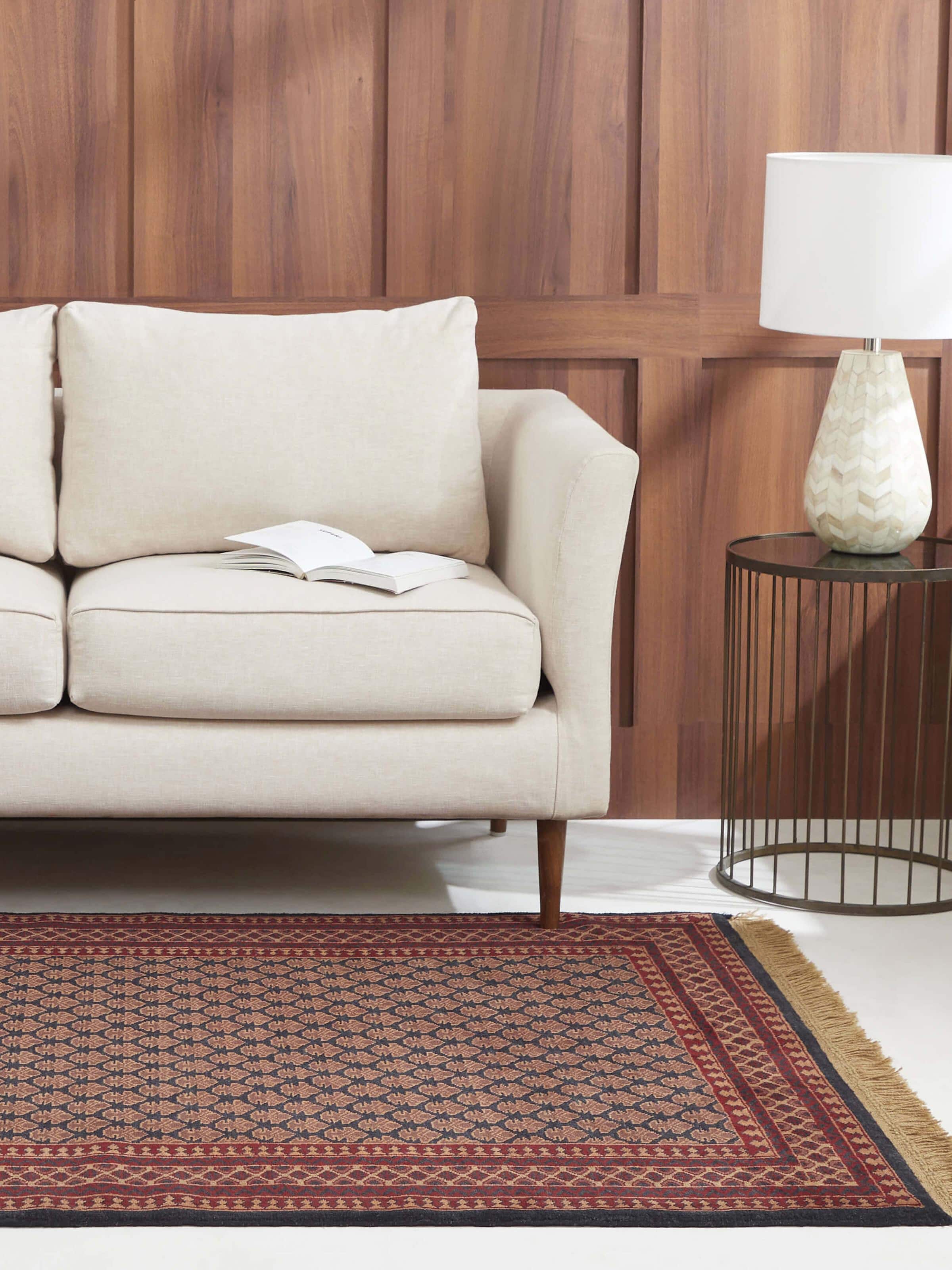 Lifestyle shot of lichi red and charcoal Gwalior wool rug in 4x6 ft size with traditional hand-knotted motifs.