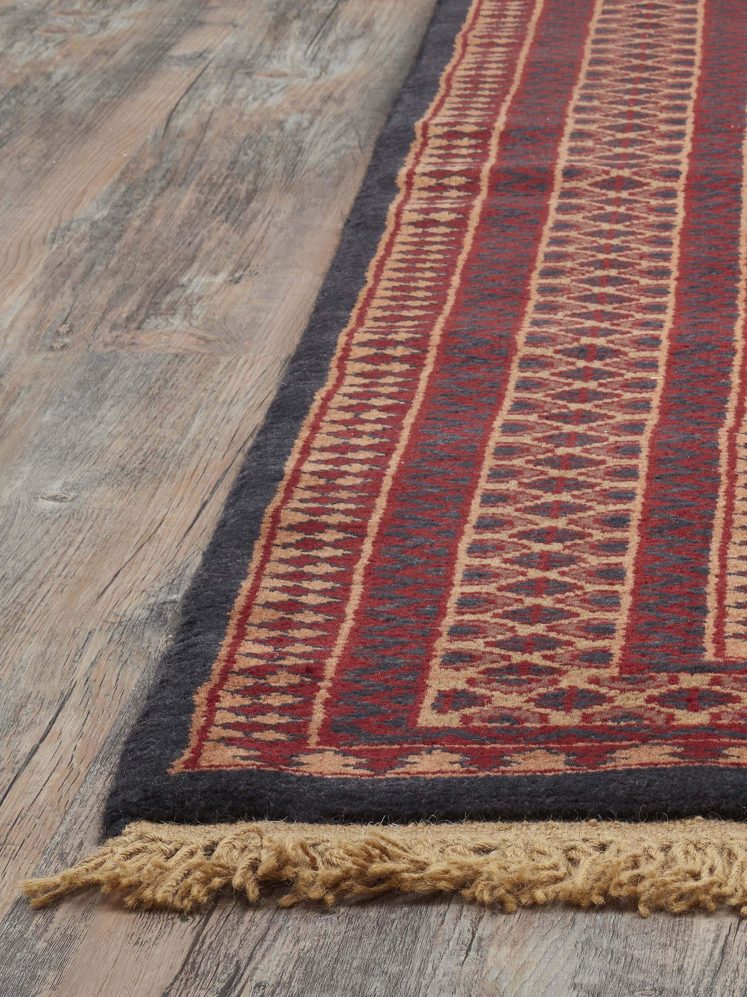 Angle view of Traditional Lichi Red Charcoal Gwalior Wool Hand-Knotted Rug (4x6 ft) highlighting pattern and craftsmanship.
