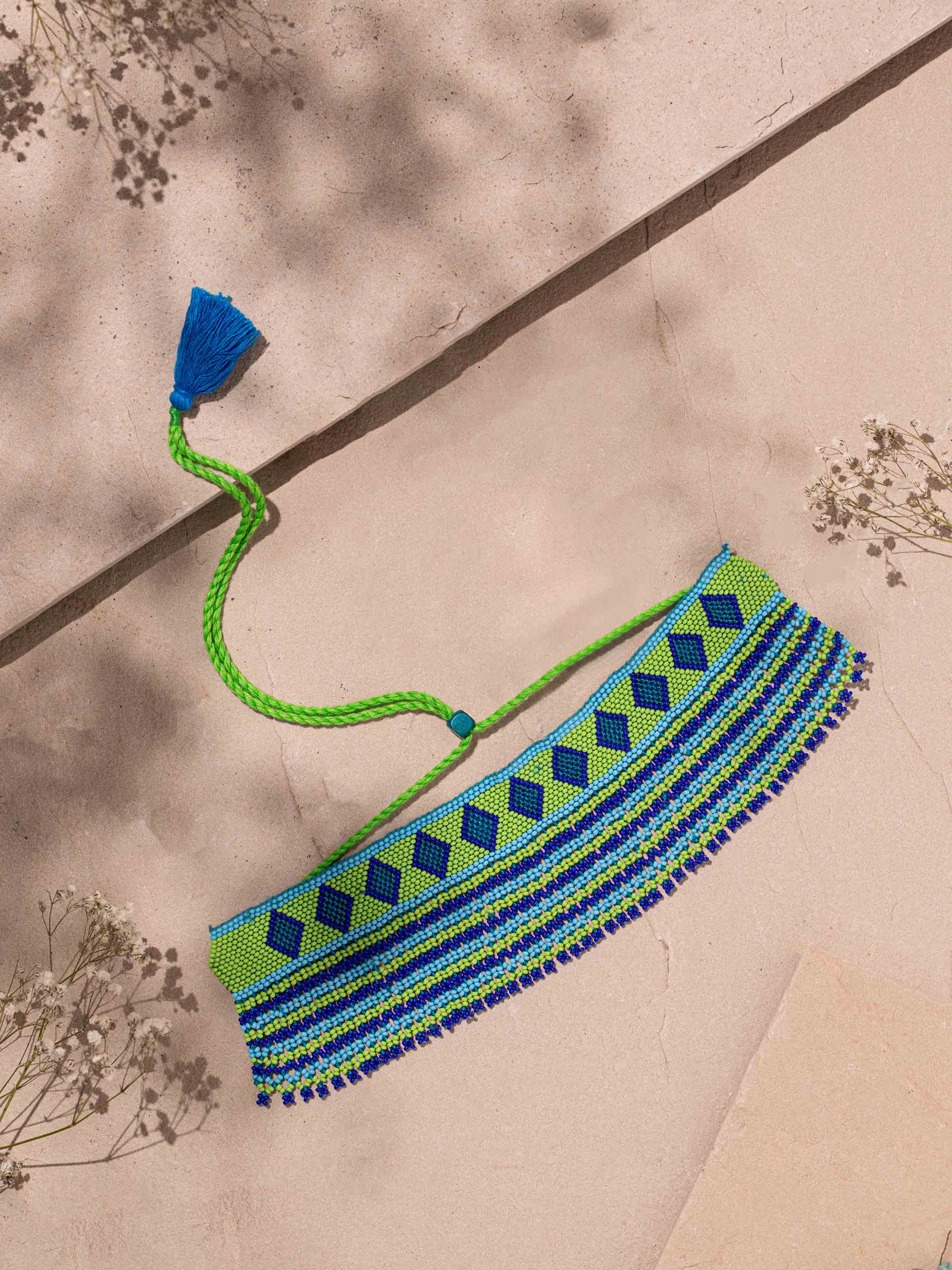 Close-up view of handcrafted collar necklace focusing on its fine details and artistic flair